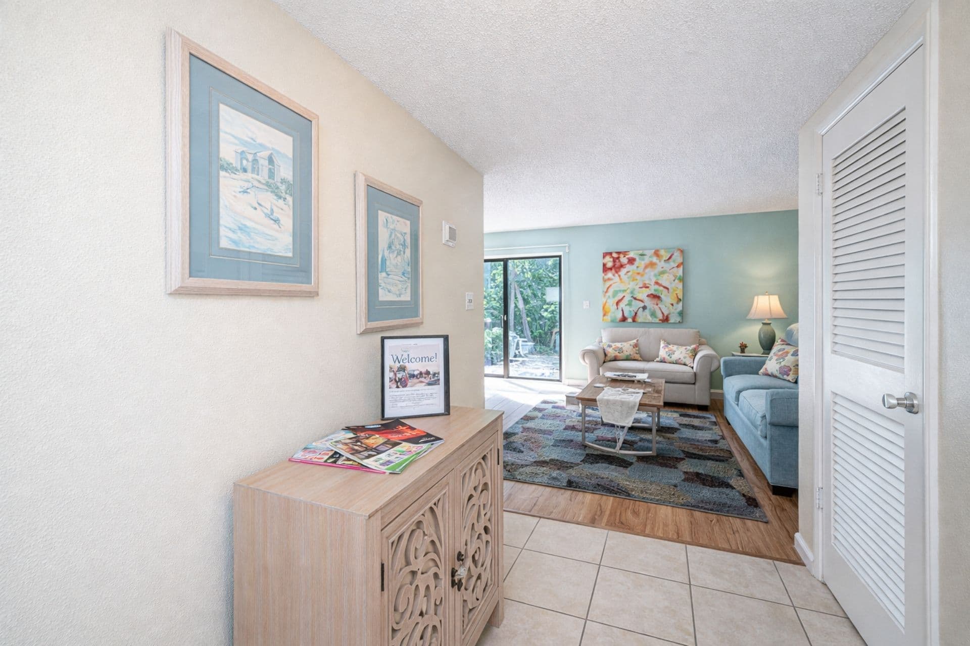 Living Room: Bright artwork and vibrant decor invite you to relax and enjoy your beach getaway!