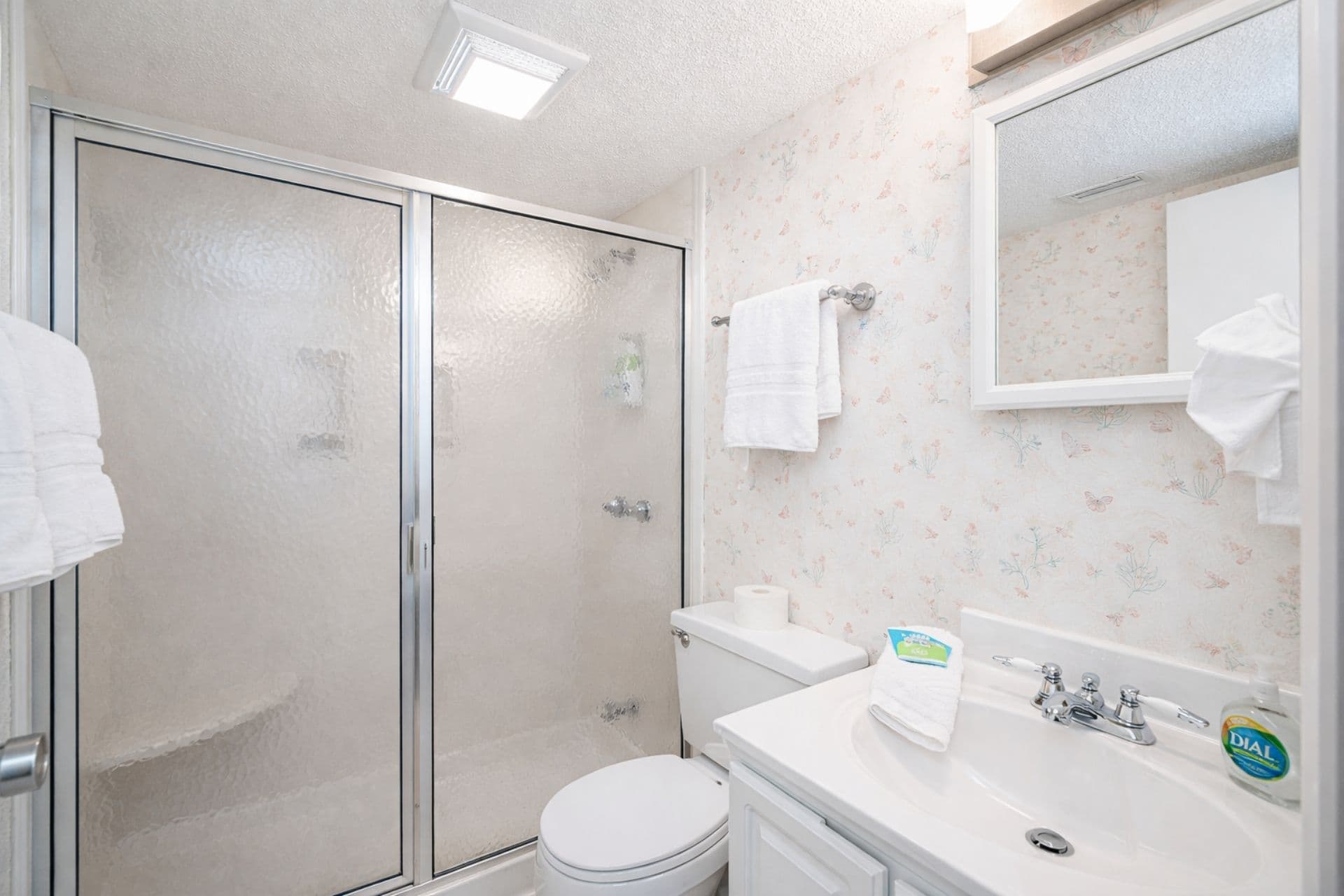 Bathroom Oasis: Bright and airy space with floral accents and modern amenities for your comfort!