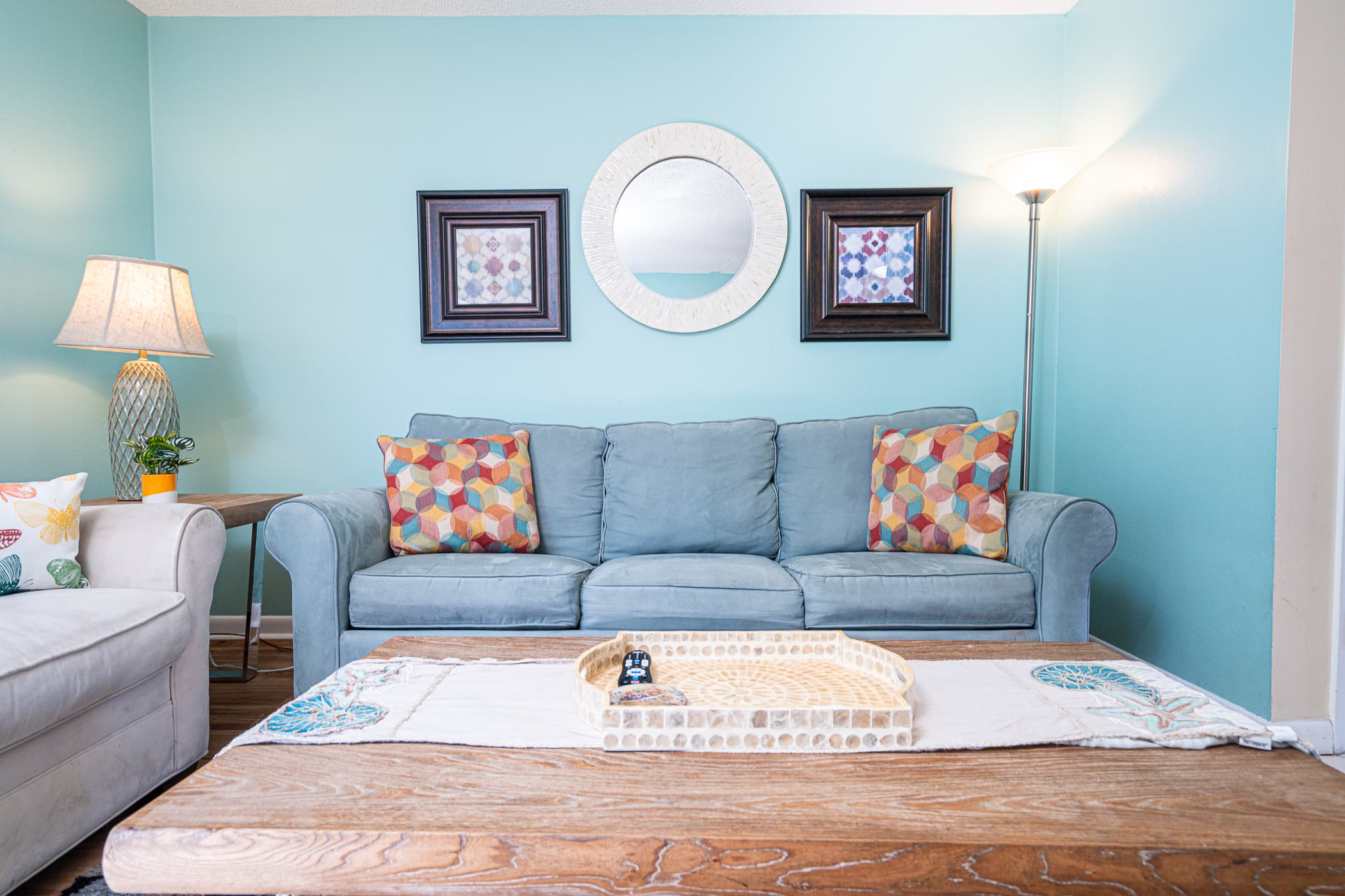 Living Room: Bright hues and comfy seating perfect for lounging after beach adventures!