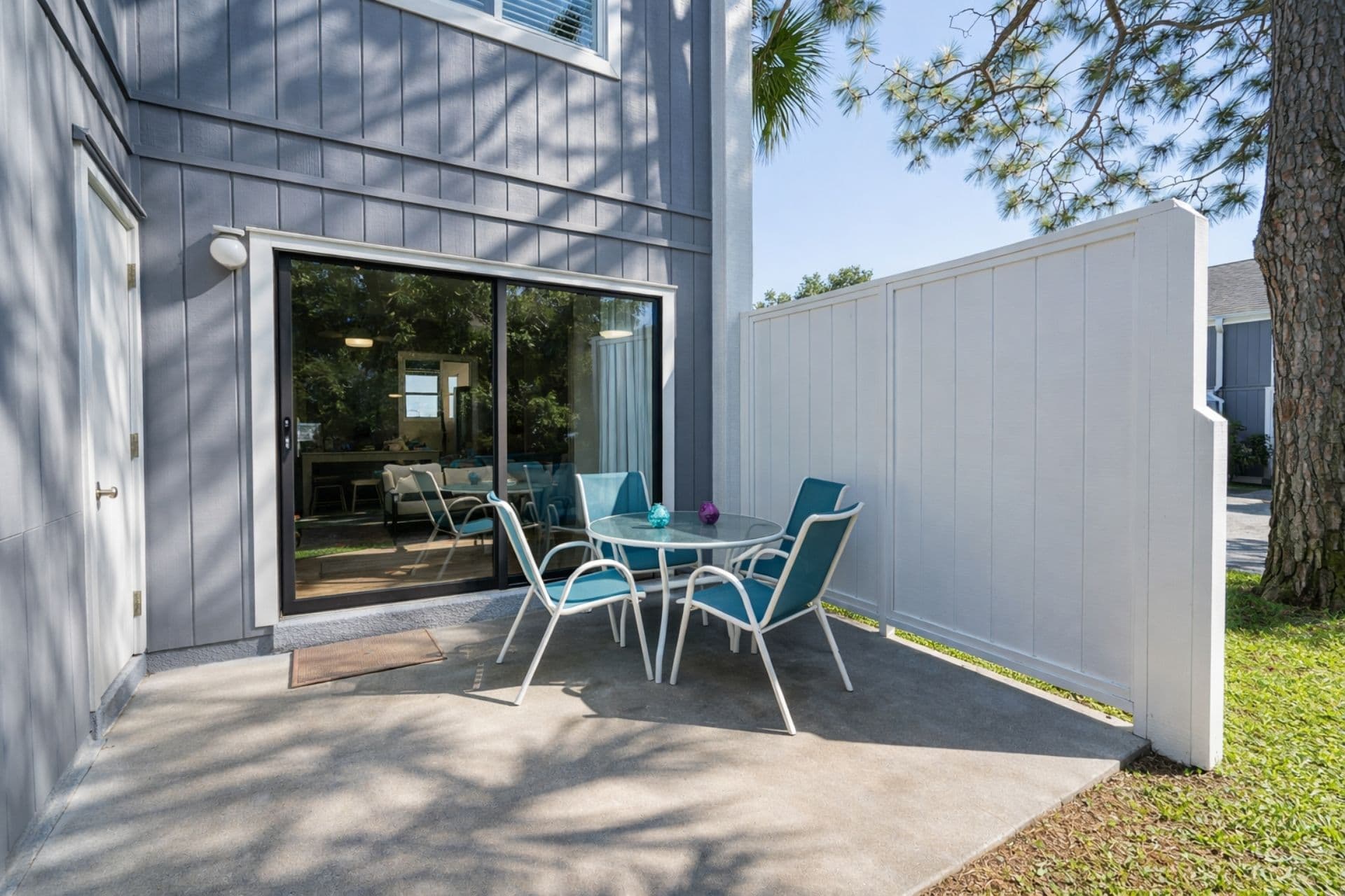 Private patio with tables, chairs and a bbq grill! Savor morning coffee in the sun with stylish seating and vibrant decor!