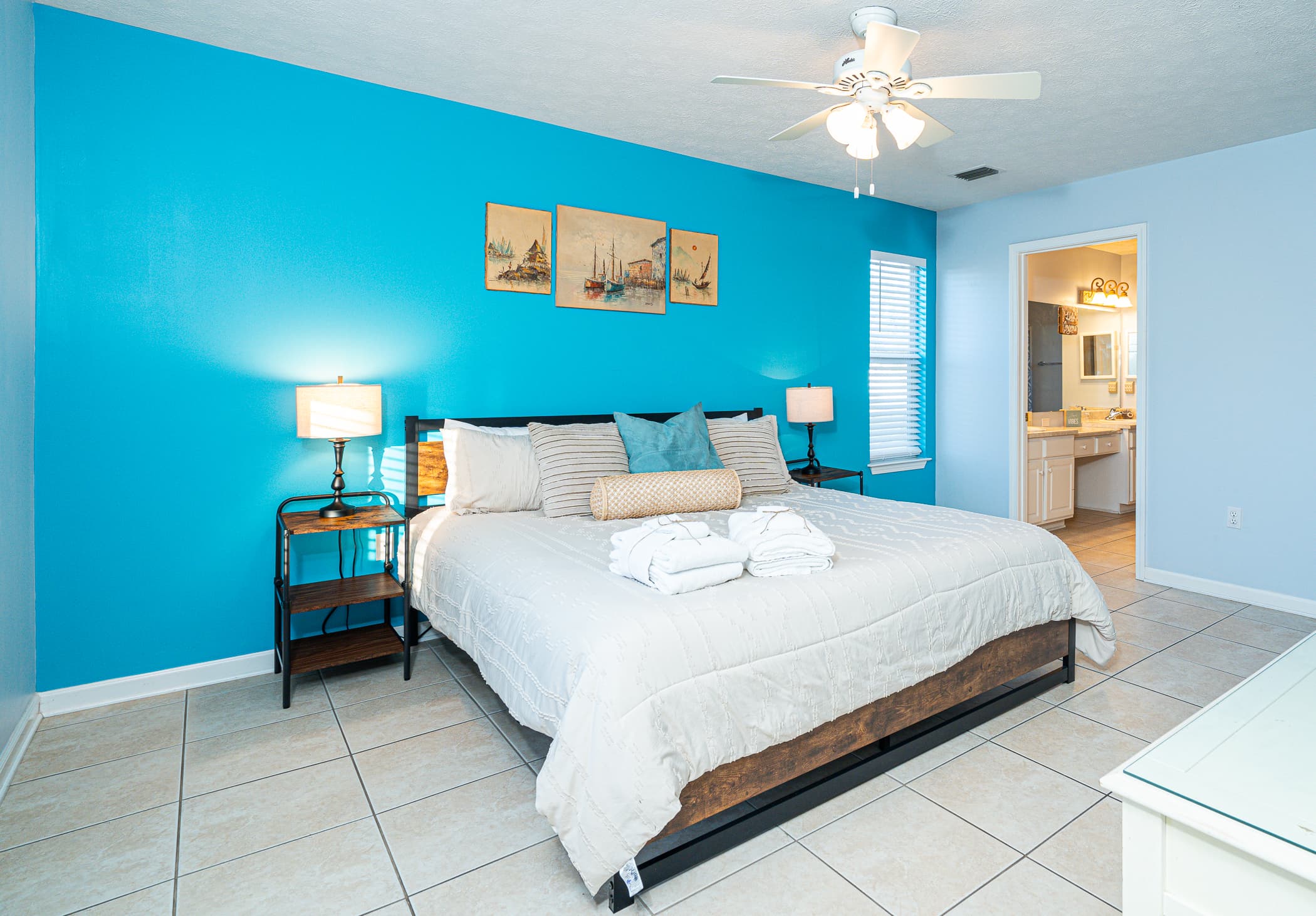 Main Bedroom: Bright walls and plush decor invite relaxation with beachside vibes! Perfect getaway!