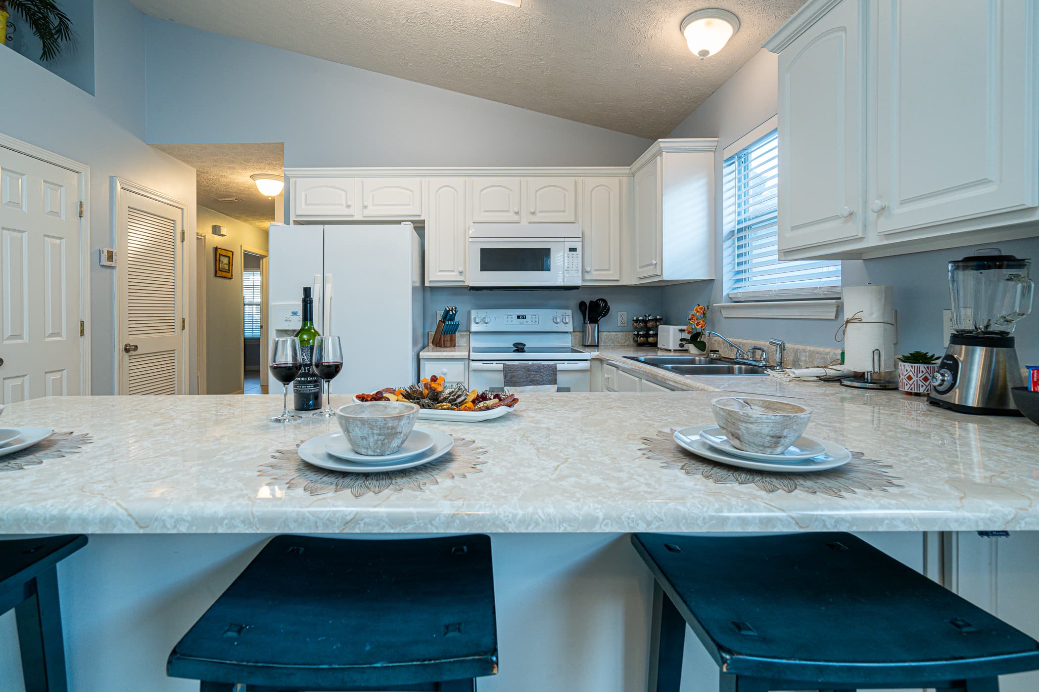 Kitchen: Whip up culinary delights at this stylishly appointed kitchen with a spacious bar!