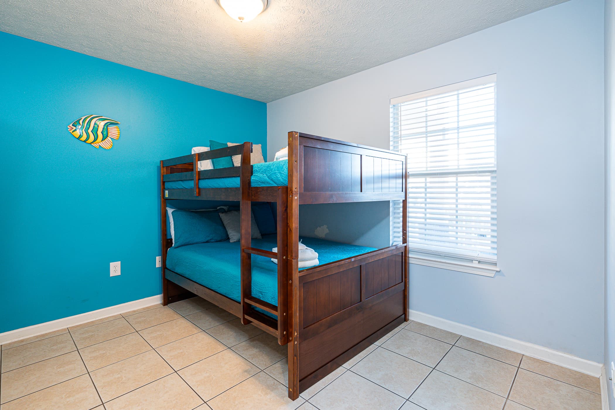 kids bedroom with bunk beds and flat tv screen