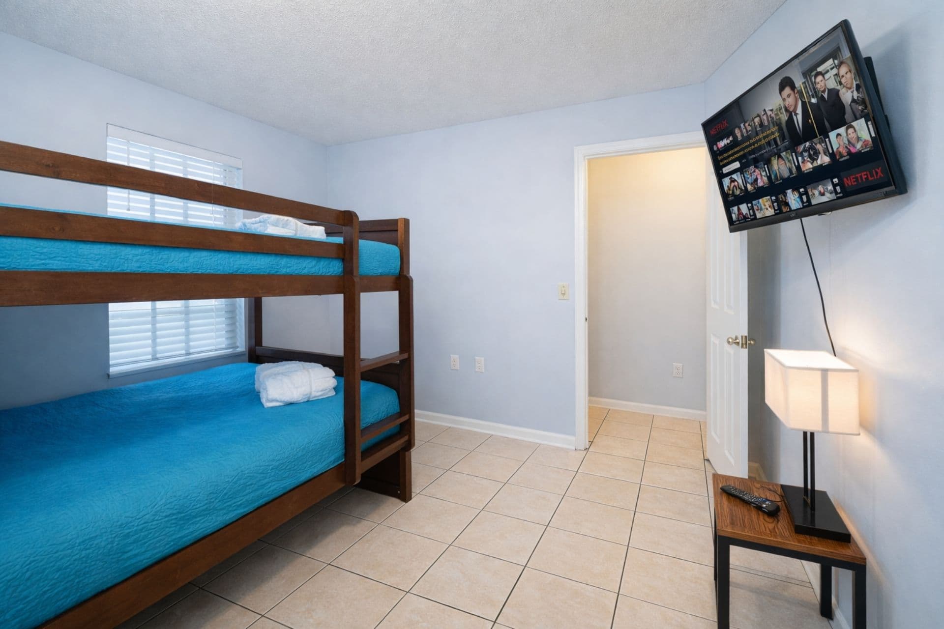 kids bedroom with bunk beds and flat tv screen