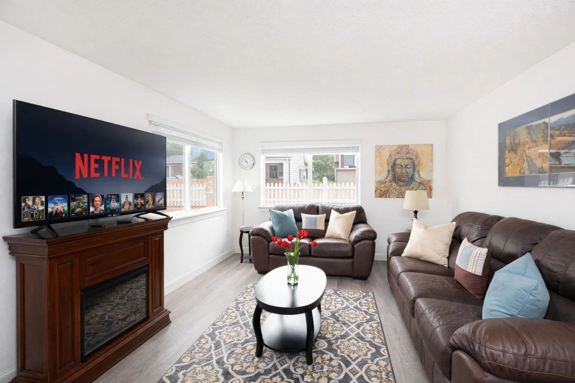 Living Area: Bright and inviting space with a plush sofa, stunning artwork, and dining nearby!