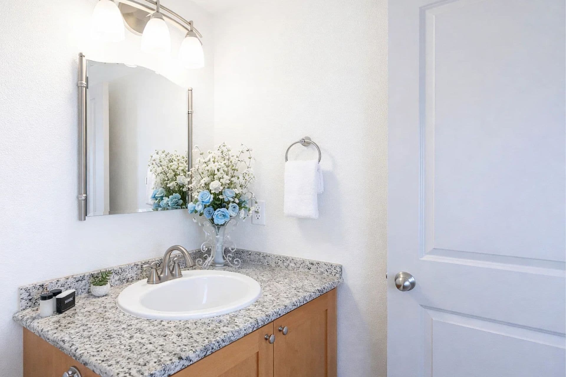 Full Bathroom: Elegant sink area with granite countertop and charming floral decor!