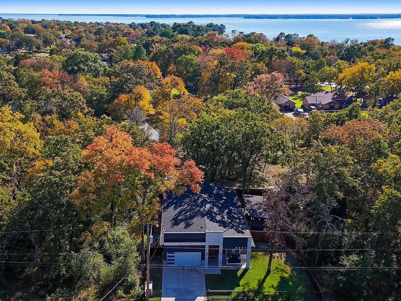 Front view of the house with Cedar Creek Lake in the background
