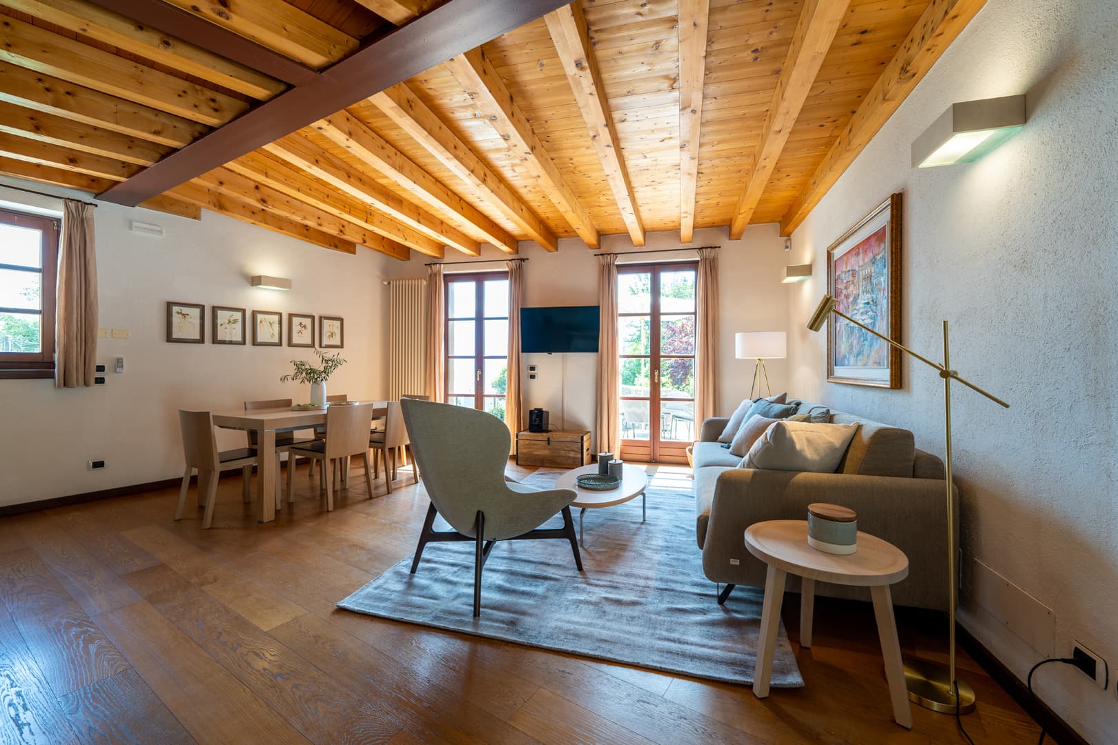 View of the living room of the annex with lake view and swimming pool