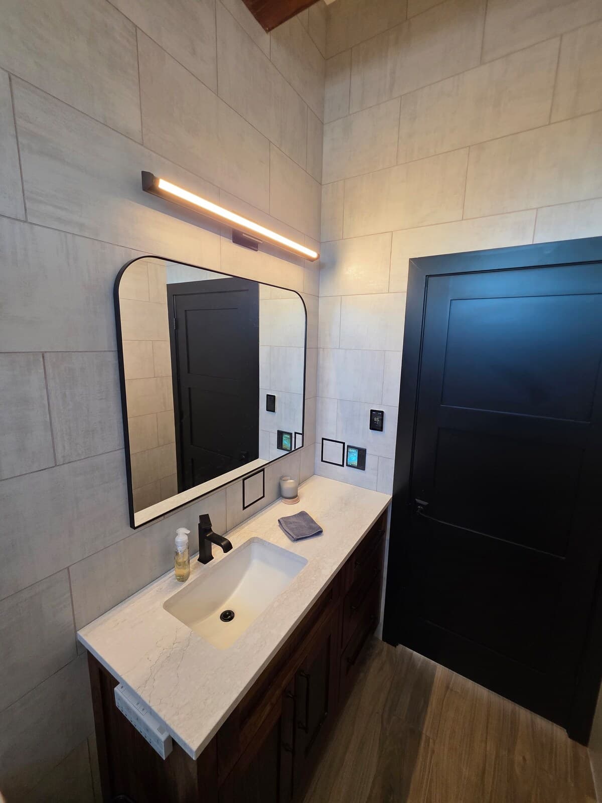 Full tile bathroom with integrated plugs, high tech switches, tile shower