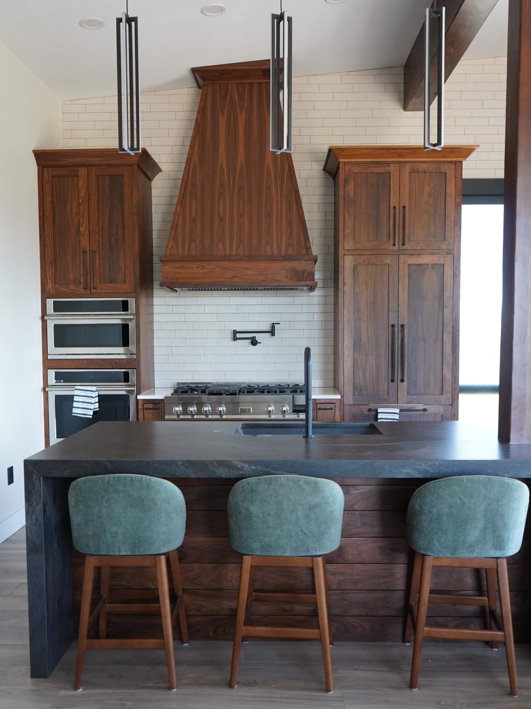Walnut kitchen with water fall island and high end appliances