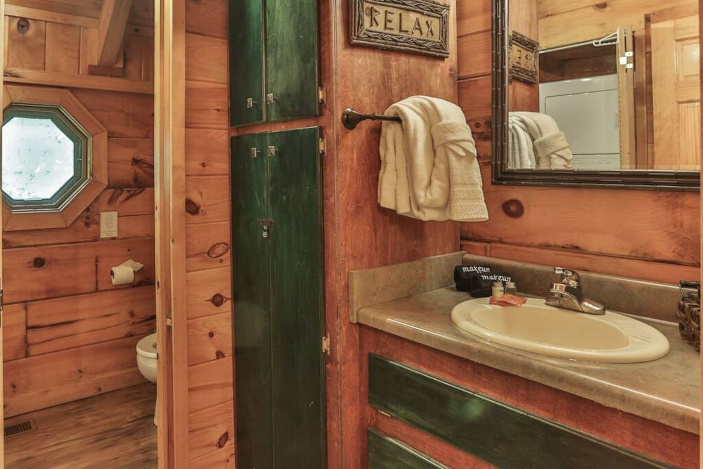 The bathroom holds the toilet, shower, and washer and dryer.