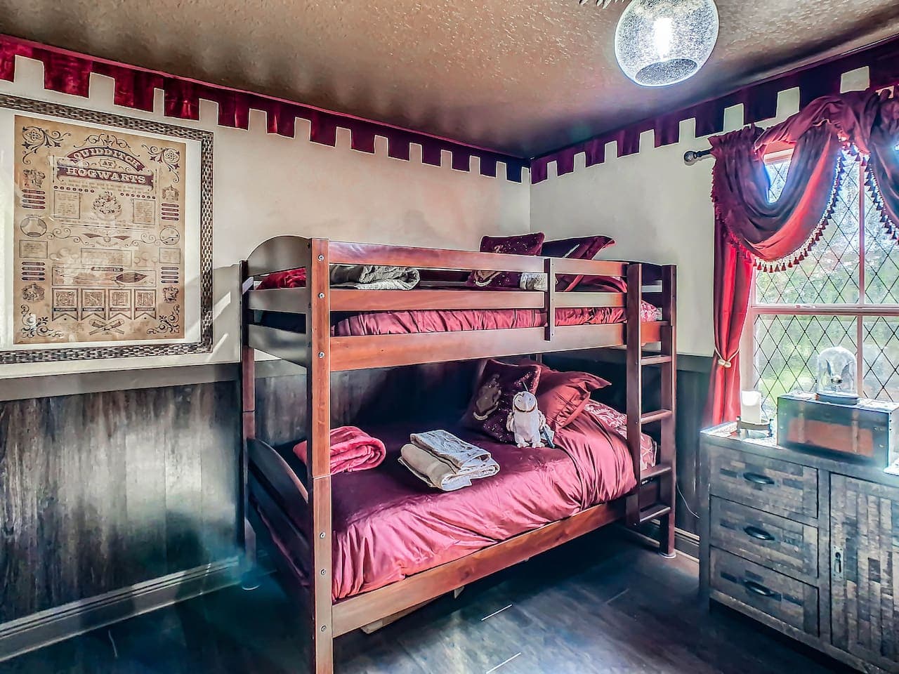 The bedroom has 2 bunk beds to sleep 4 people and an owl overhead light and snitch night light.