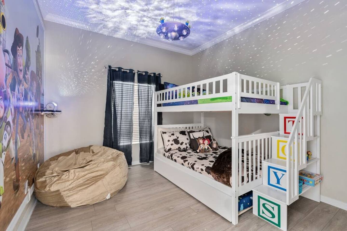 Woody theme on the bottom bunk and Buzz Lightyear theme on the top. The bunk bed also has a pullout trundle for extra sleeping and a bean bag for watching TV!