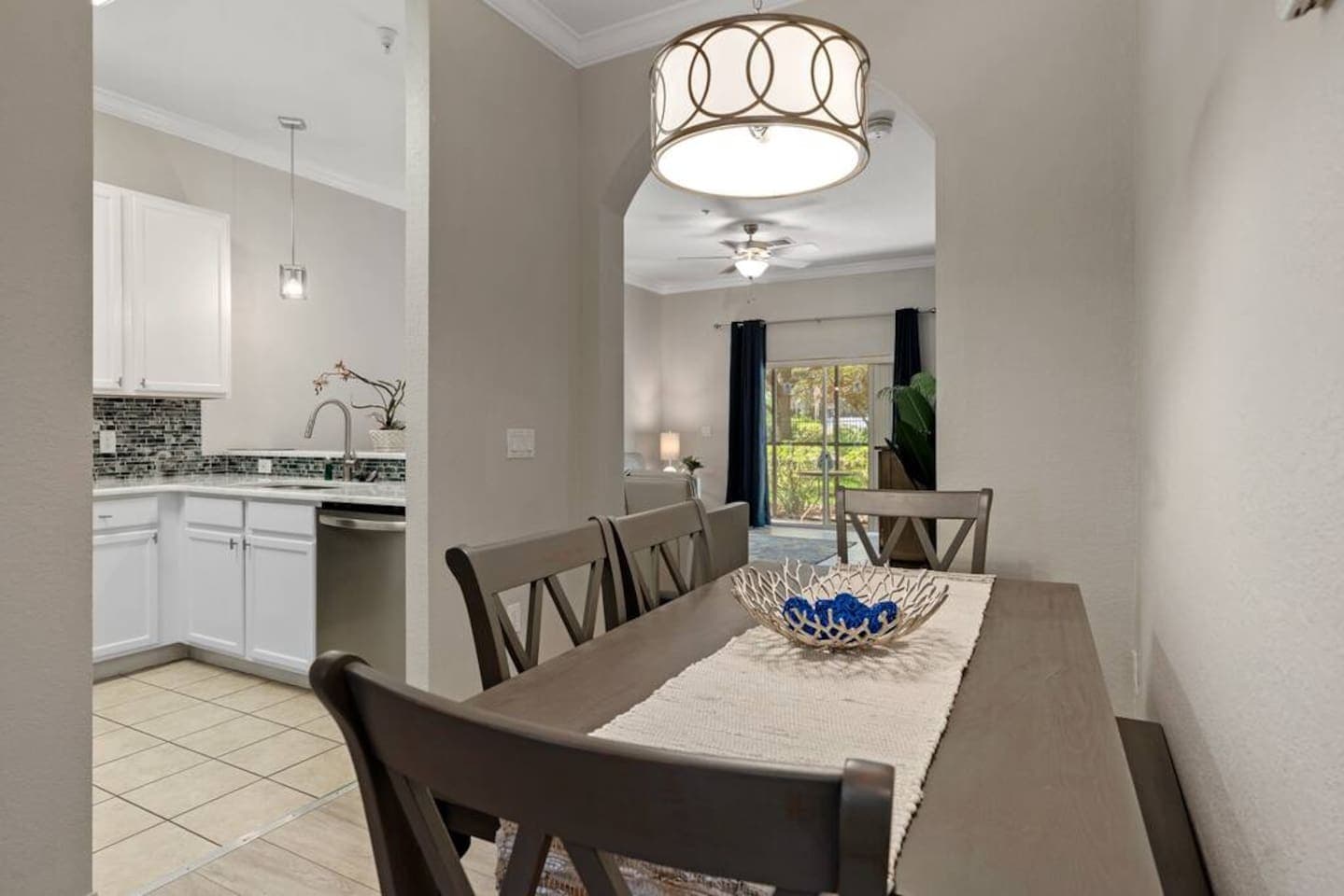 The dining table has a bench tucked under the table, allowing 6 to eat together