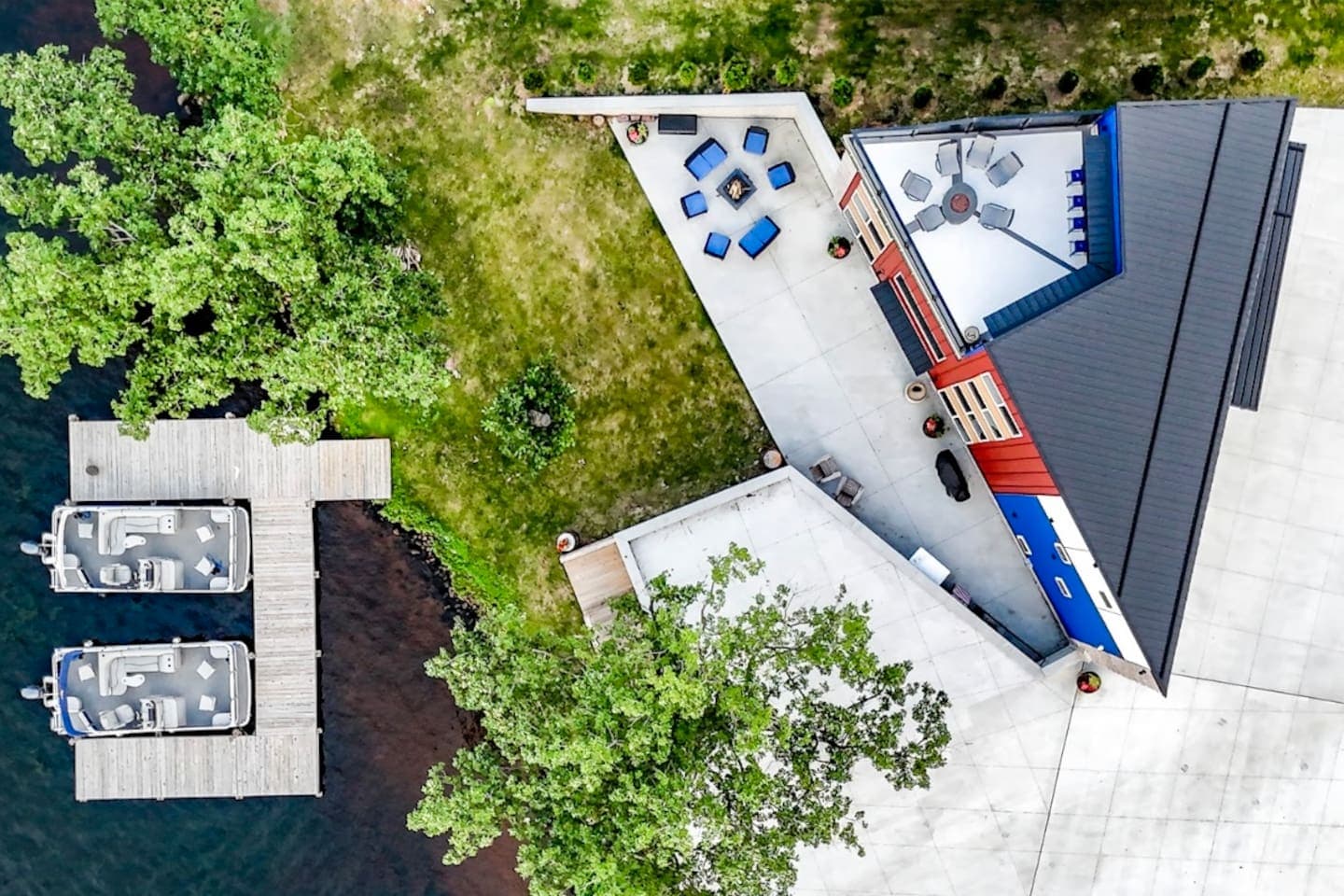 Aerial view of "Triangle House" property with rooftop deck, walkout basement, lake access and ample parking.
