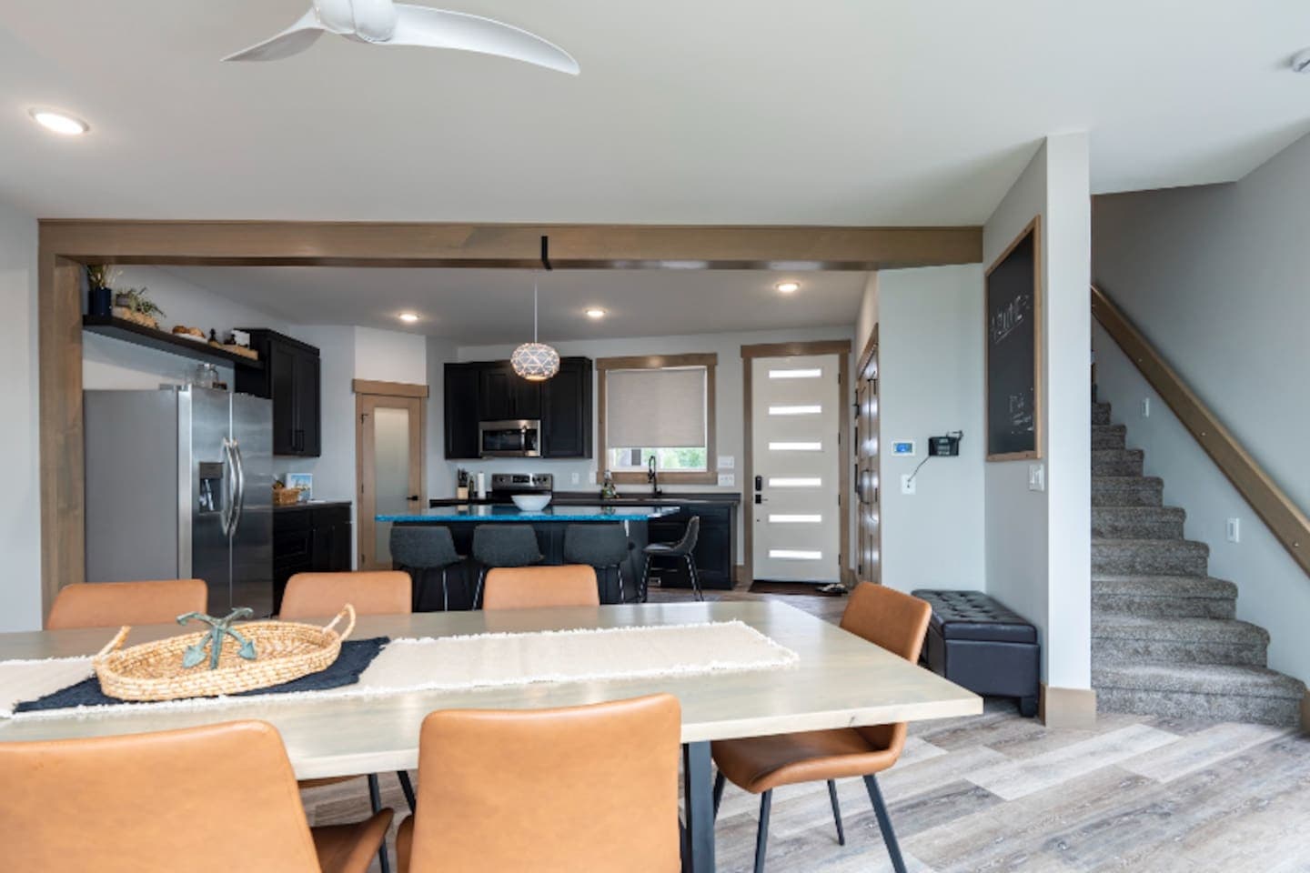 Dining room features custom maple table and leather seating with plenty of natural light.
