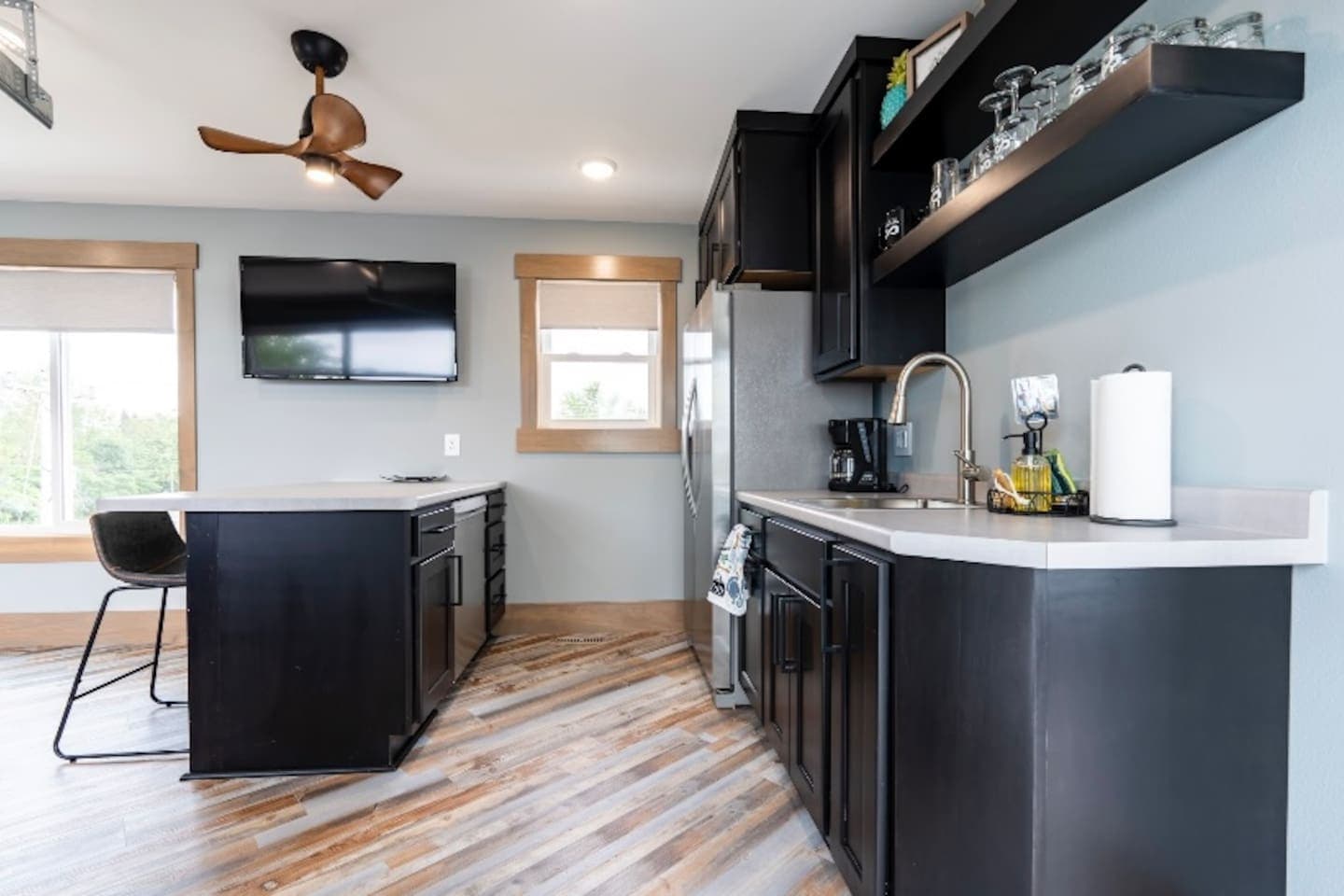 Top floor kitchenette (same floor as game room and rooftop deck) features fridge/freezer, sink, dishwasher, coffee maker, and plenty of drinkware.