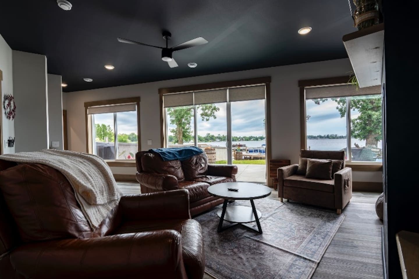 Living room with views of the lake and plenty of natural light.