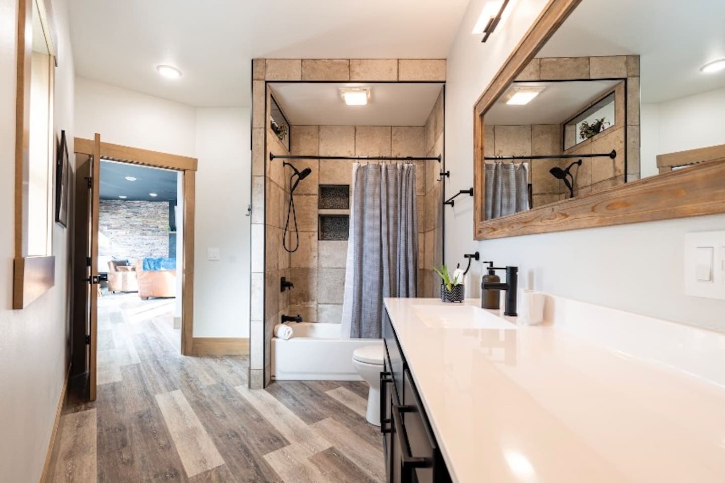Bathroom 1 is spacious with tub, toilet, and plenty of countertop space.