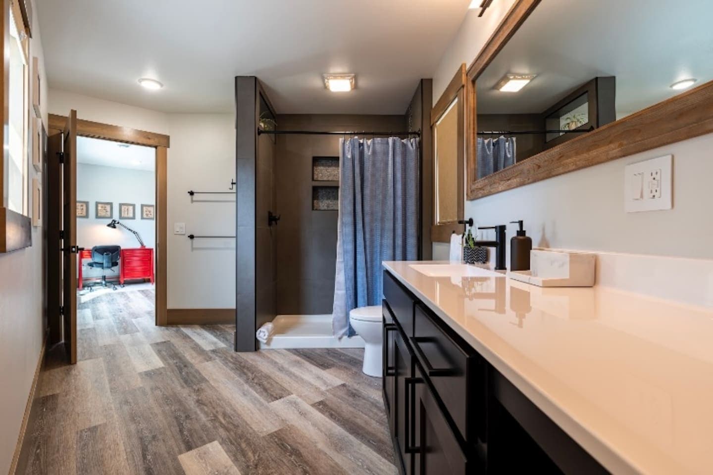 Bathroom 3 with tiled shower, toilet, and plenty of countertop space.