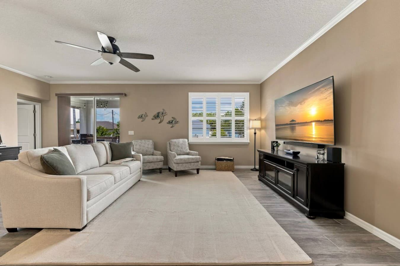 Enjoy plenty of comfortable seating, a 75-inch wall-mounted TV, and a collection of family-friendly games conveniently stored in the hutch behind the sofa.