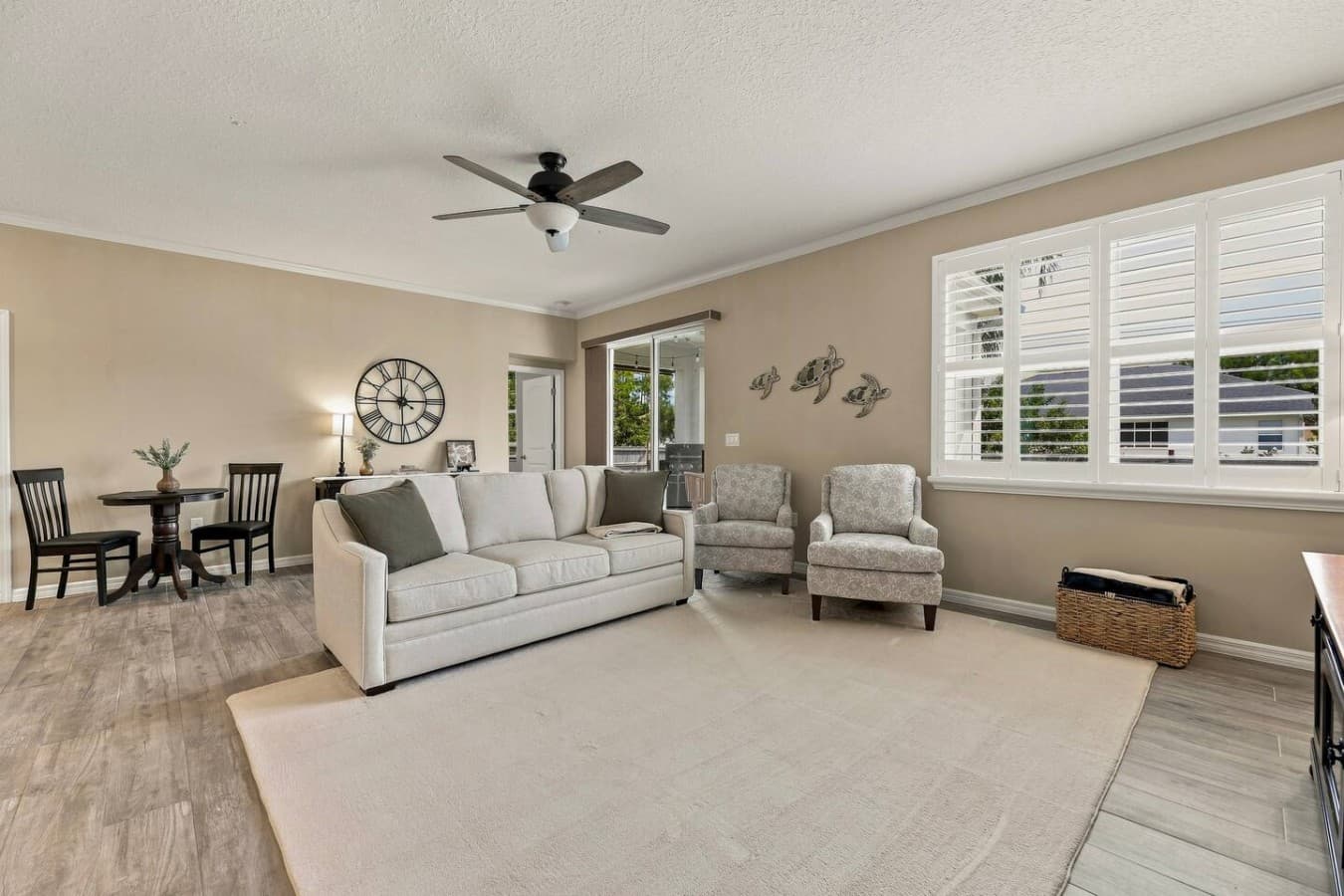 Relax in the spacious living area with two additional sectional chairs, a wall-mounted 75-inch TV, and kid-friendly games stored in the hutch behind the couch.