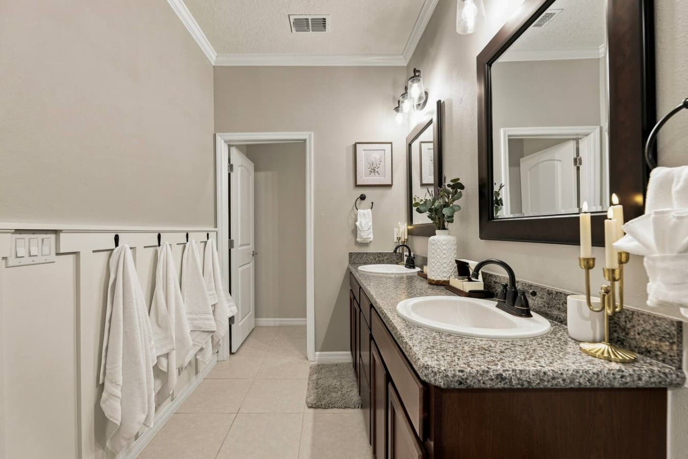 The spacious bathroom features a double vanity, generous counter space, and fresh towels for your stay.