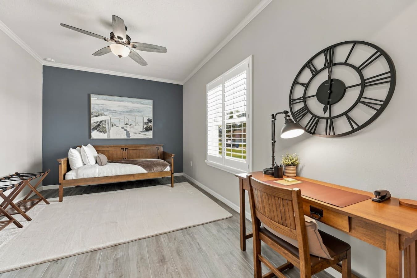 Unwind in bedroom three, furnished with a comfortable twin daybed and luggage racks for easy unpacking.