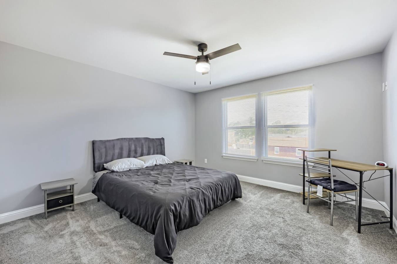 Queen bed and work station in bedroom one.