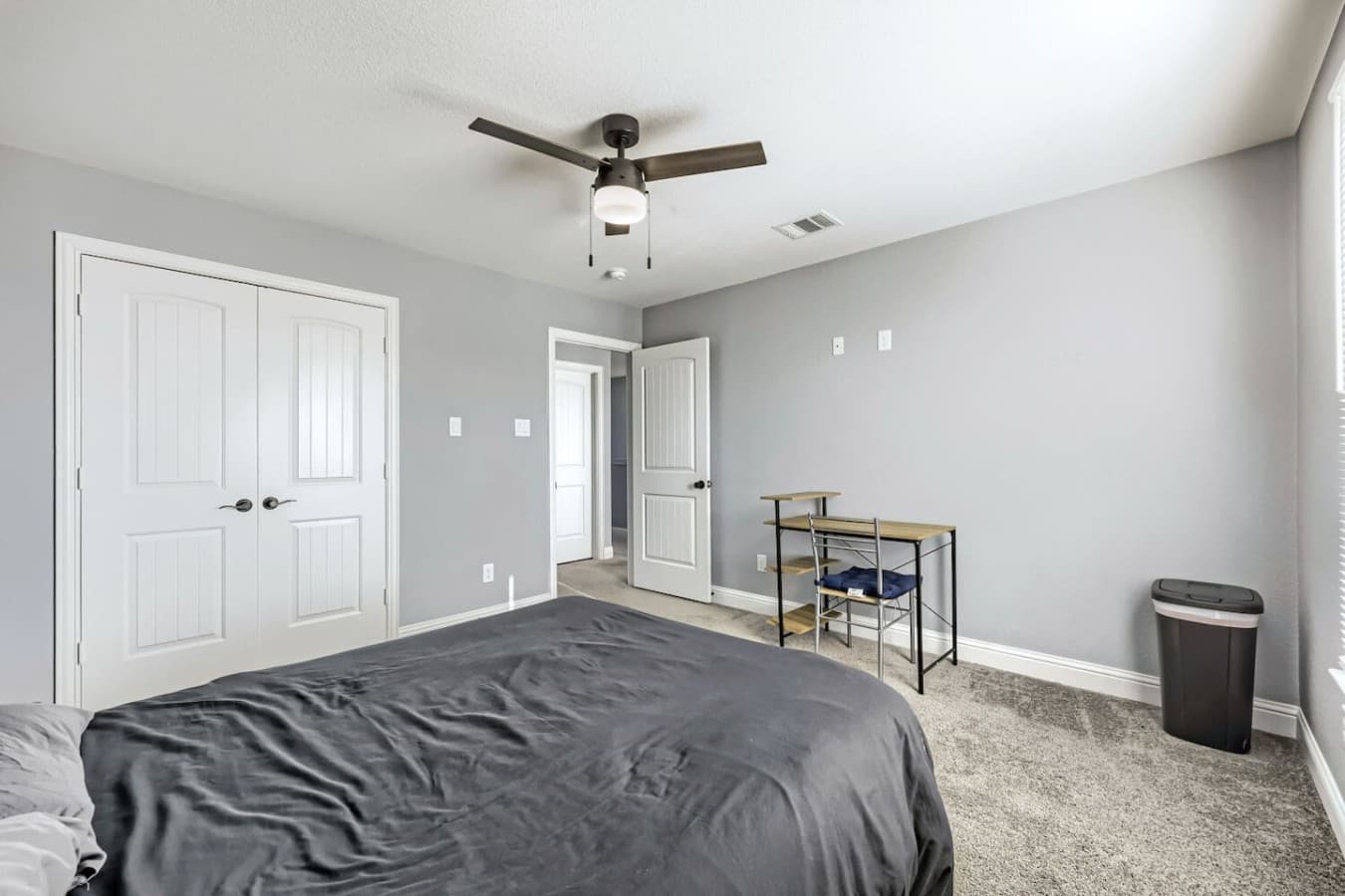 A queen bed and dedicated workstation make this room ideal for rest and productivity.