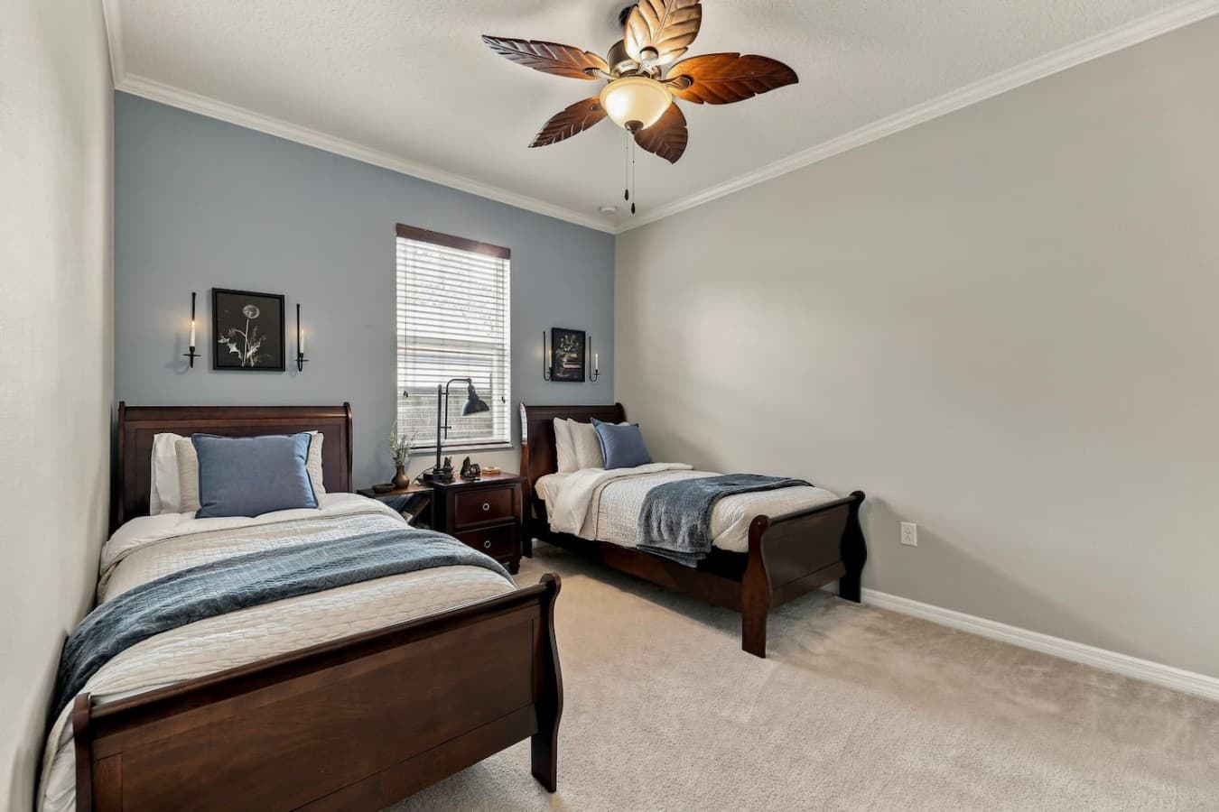 This comfortable bedroom features two single beds, perfect for children, friends, or individual guests.