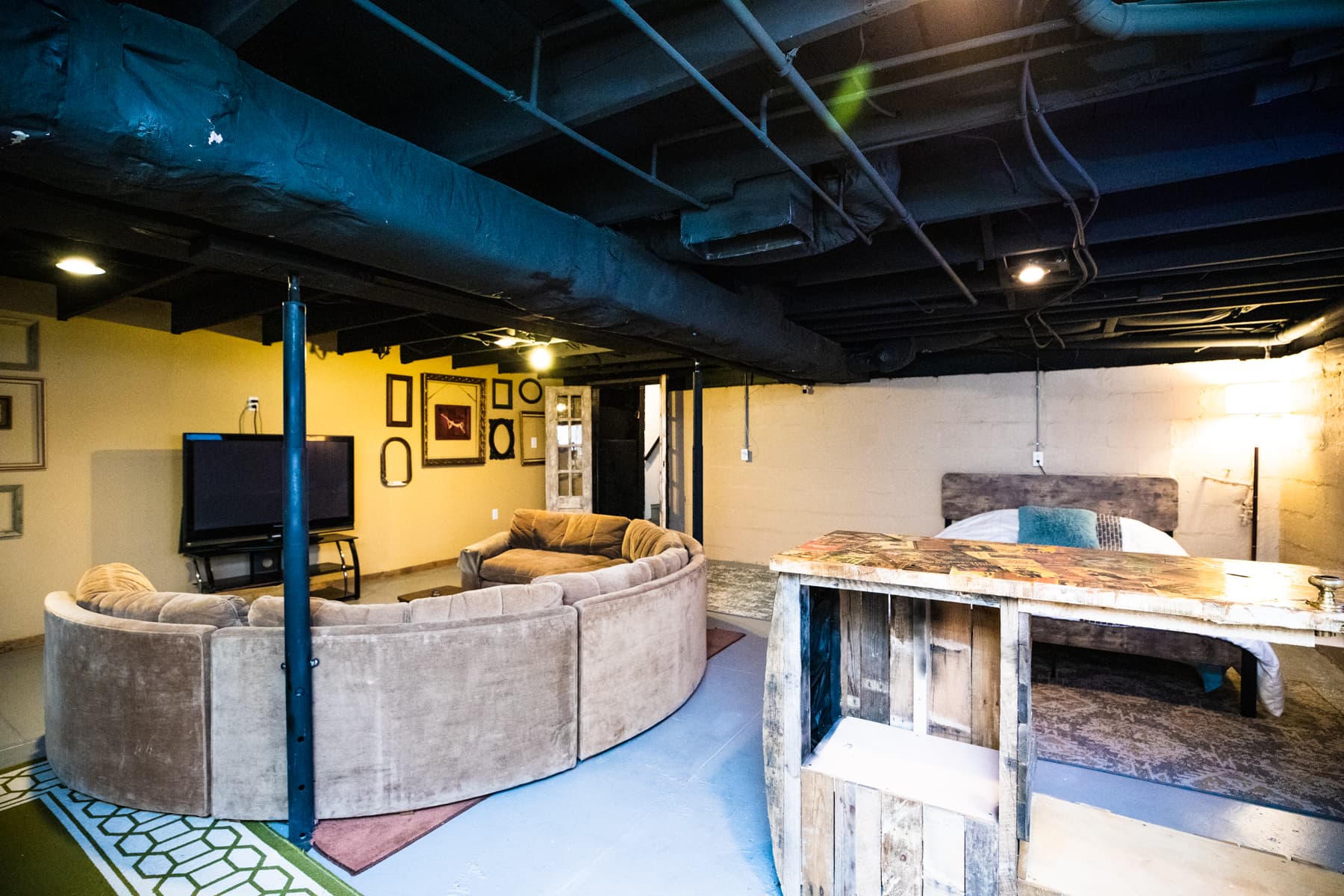 Basement, large circular couch, bar