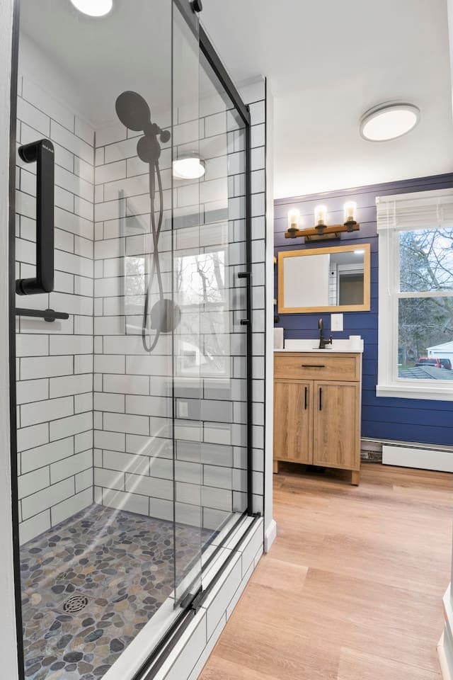 Bathroom with glass shower and wood vanity