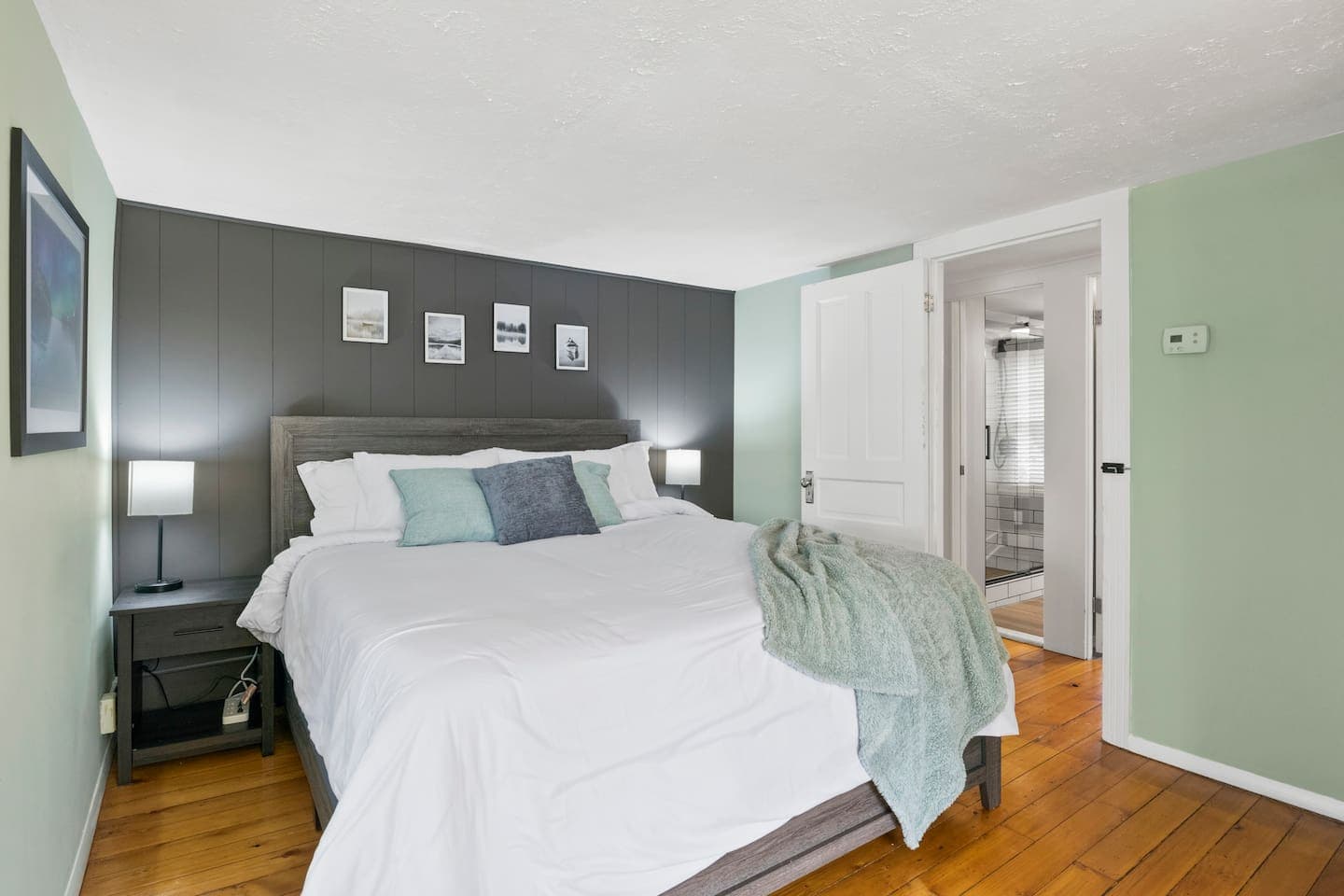 Bedroom with grey accent wall and white linens