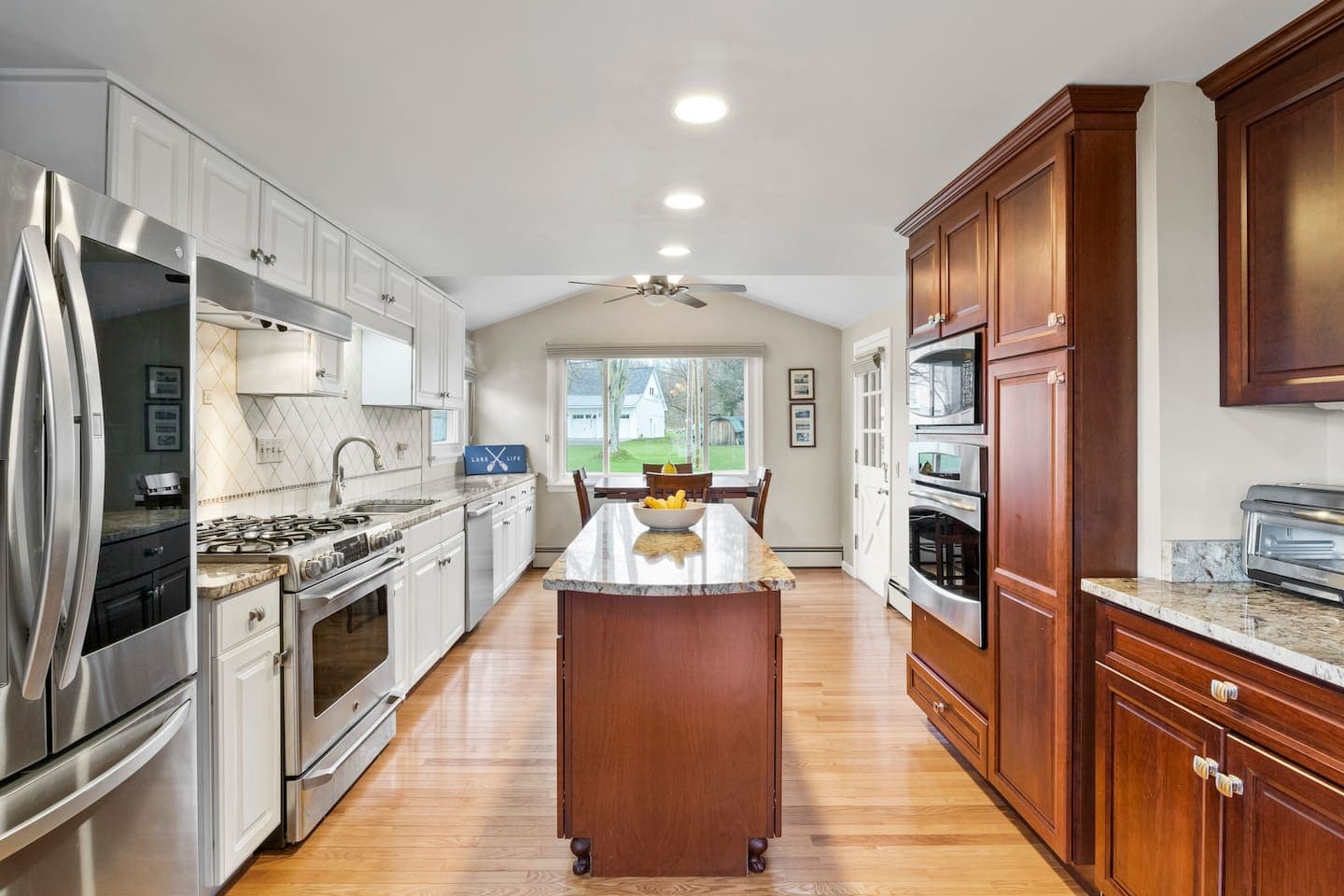 Galley kitchen with wood cabinetry and island