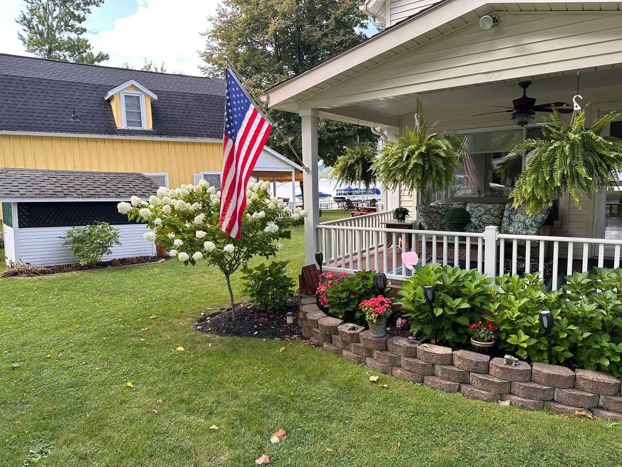 Landscaped exterior with covered front porch
