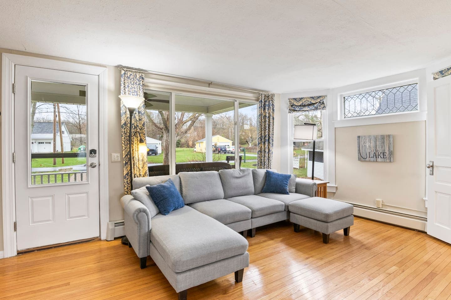 Window-lined living room with sectional seating