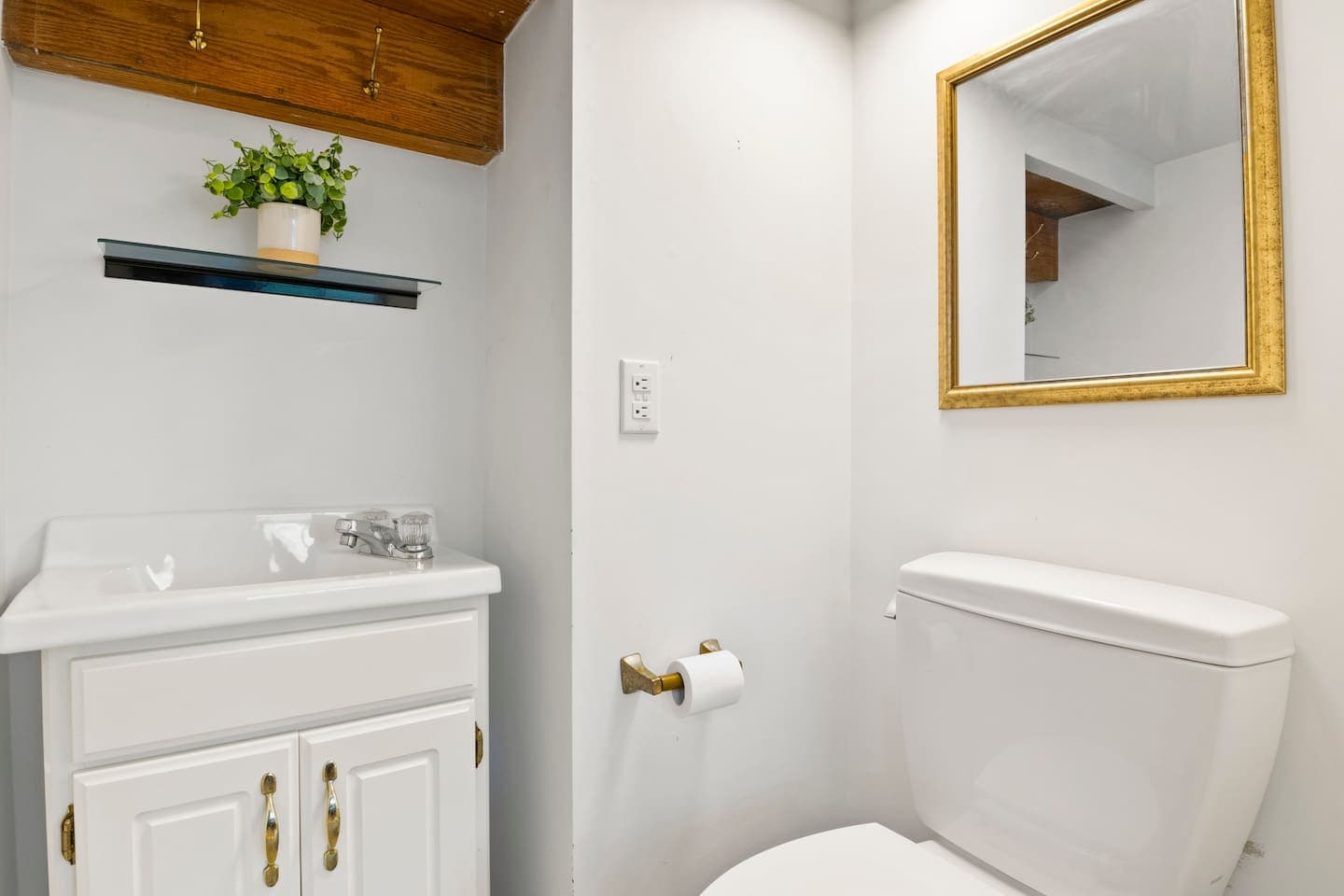 Compact half bathroom with wall-mounted sink