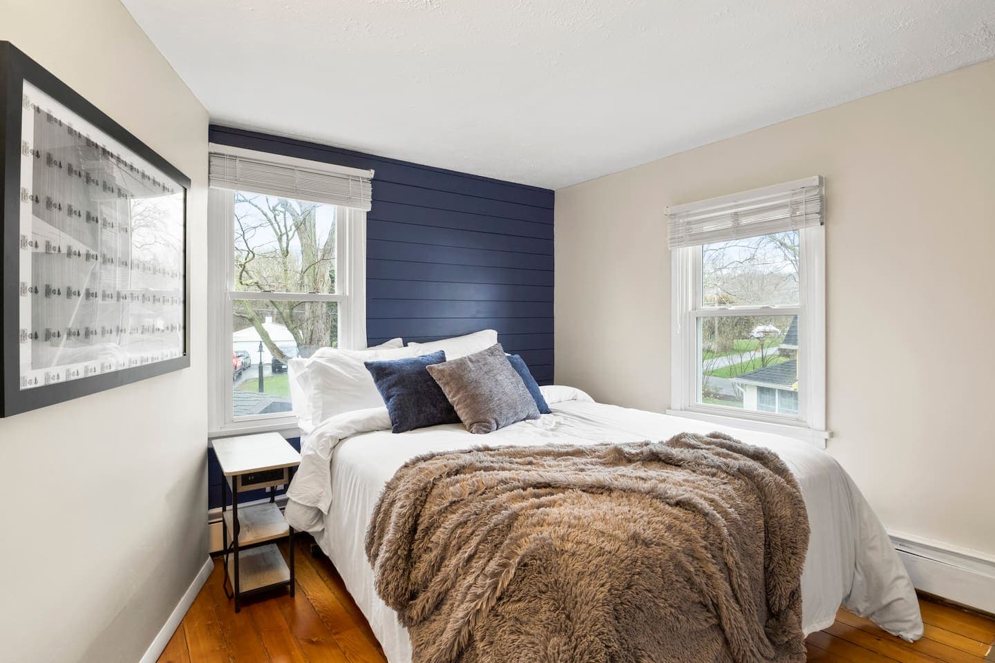 Bedroom with dark accent wall and natural light