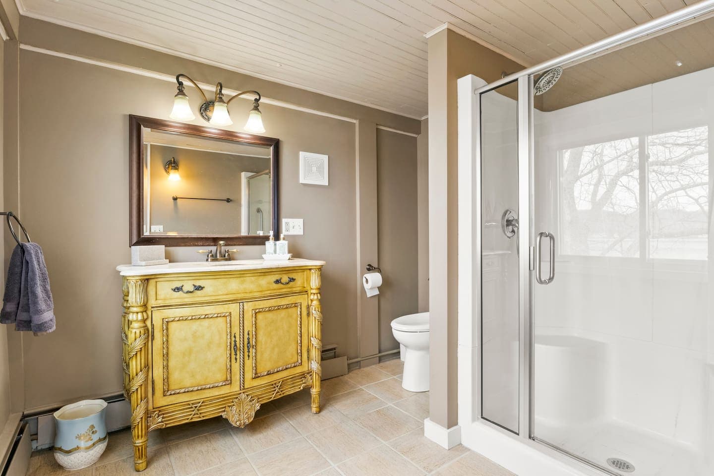 Bathroom with framed mirror and glass shower