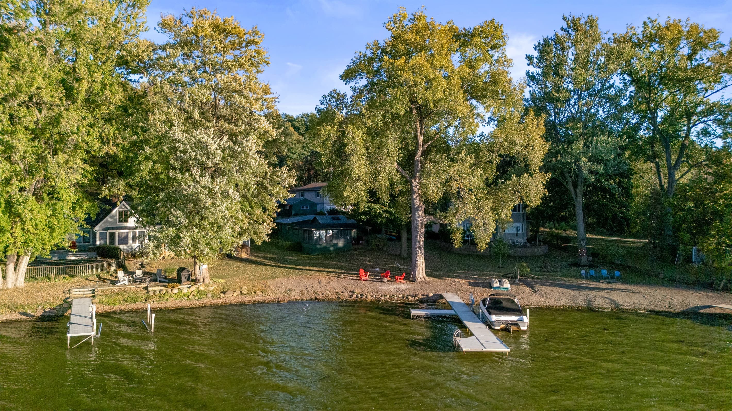 House viewed through trees from the lake