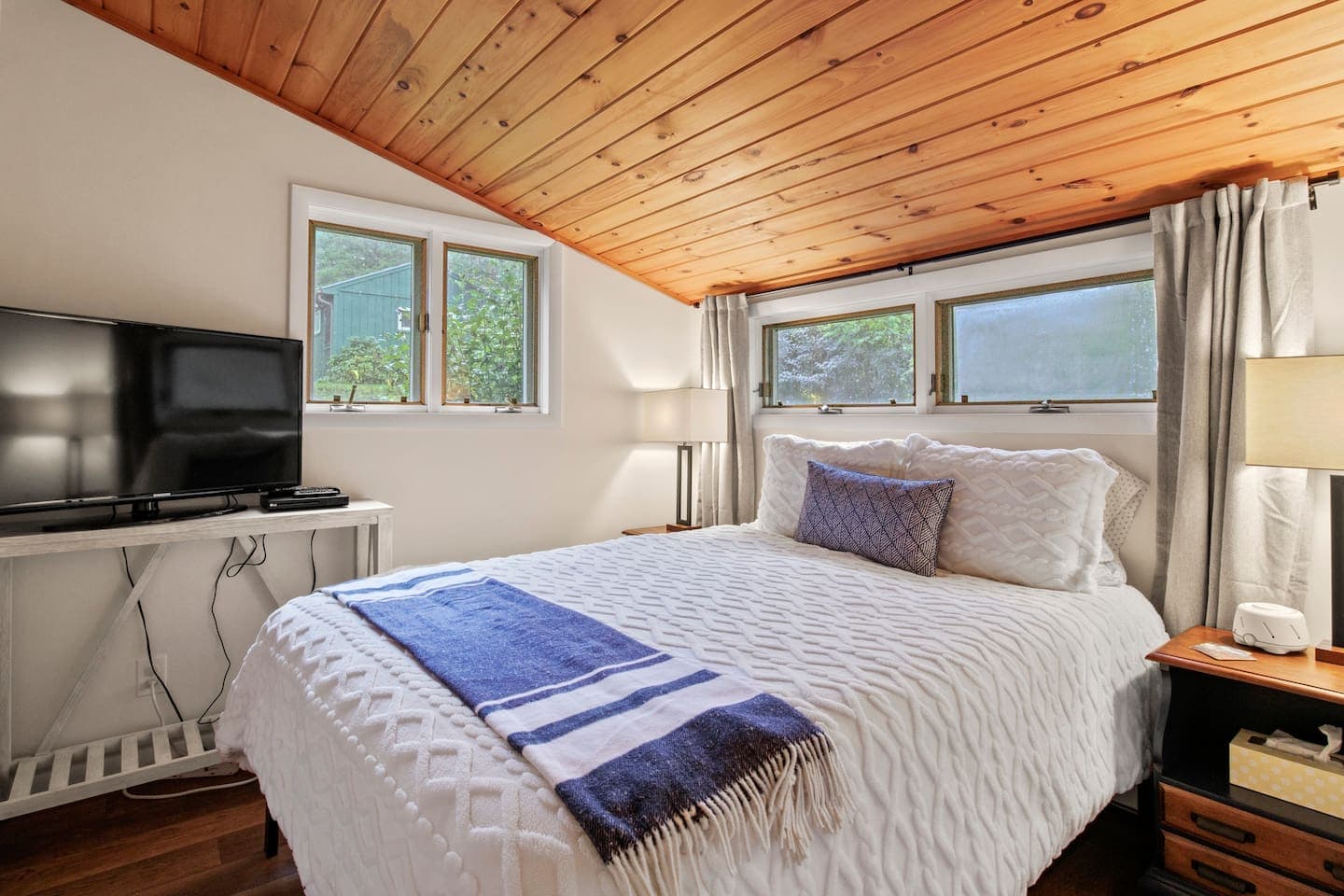 Bedroom with wood ceiling and tv