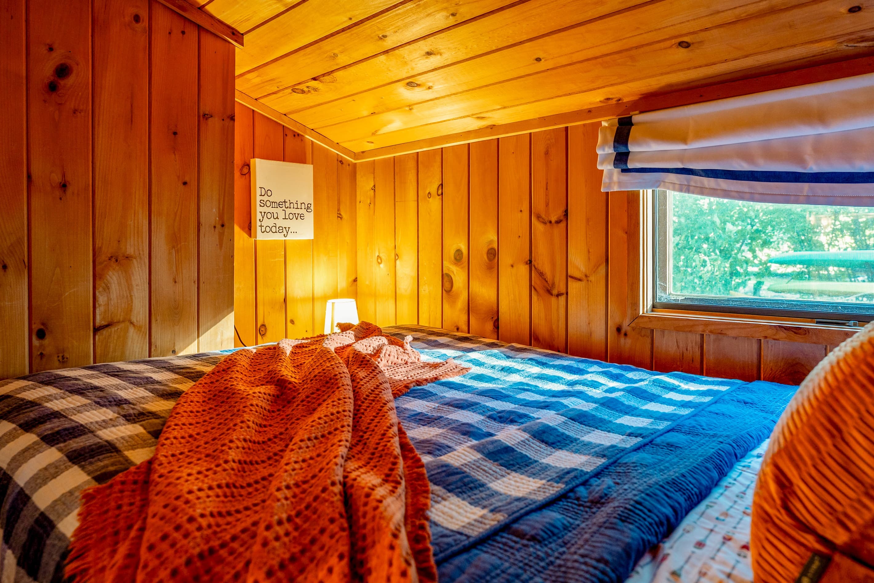 Wood-paneled bedroom with double bed 
