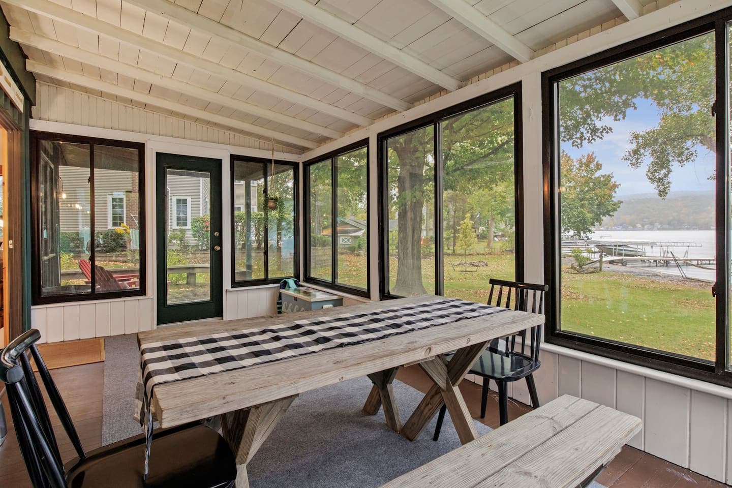Screened lakeside porch with dining table