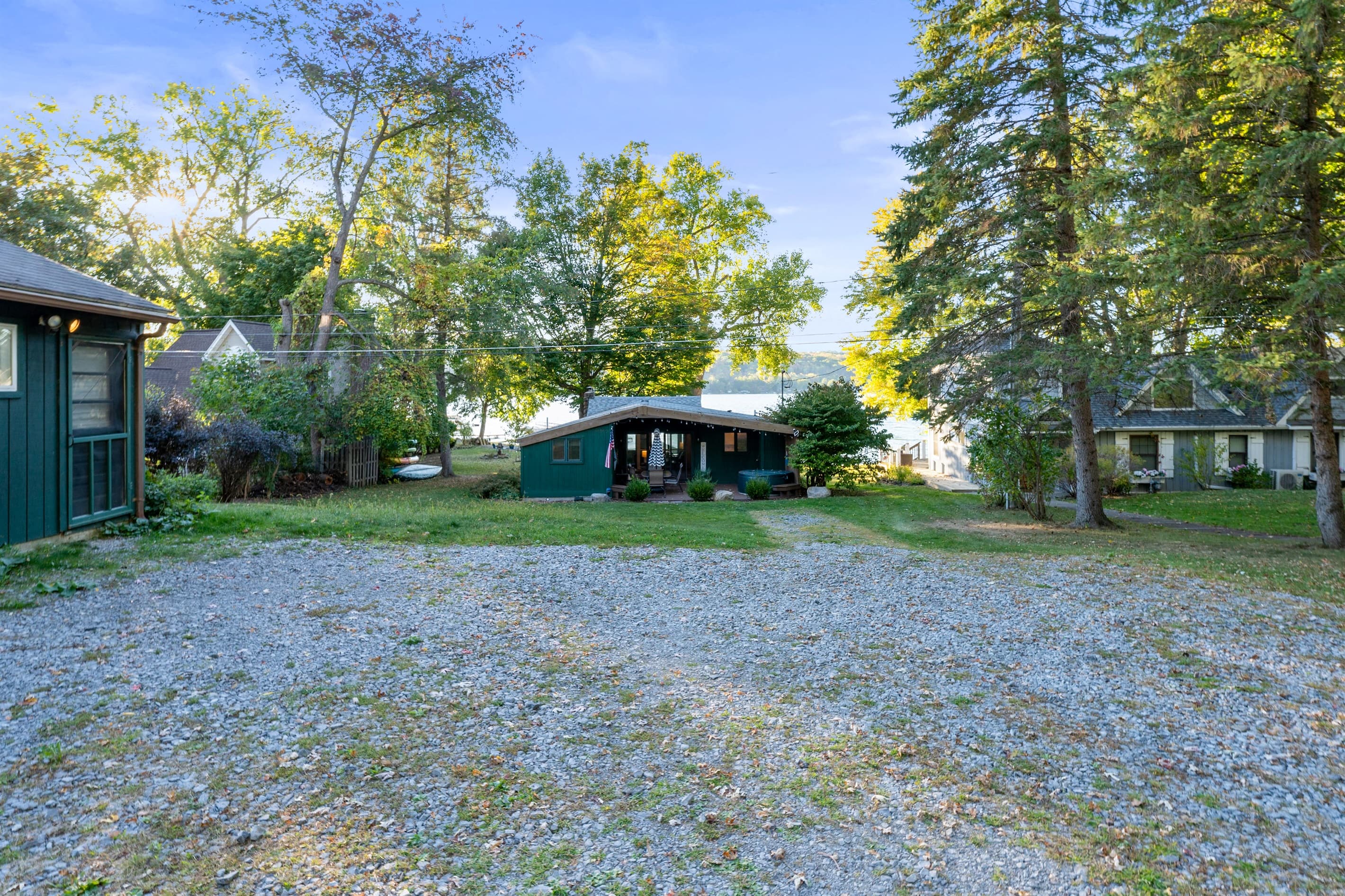 Spacious lawn with gravel parking area