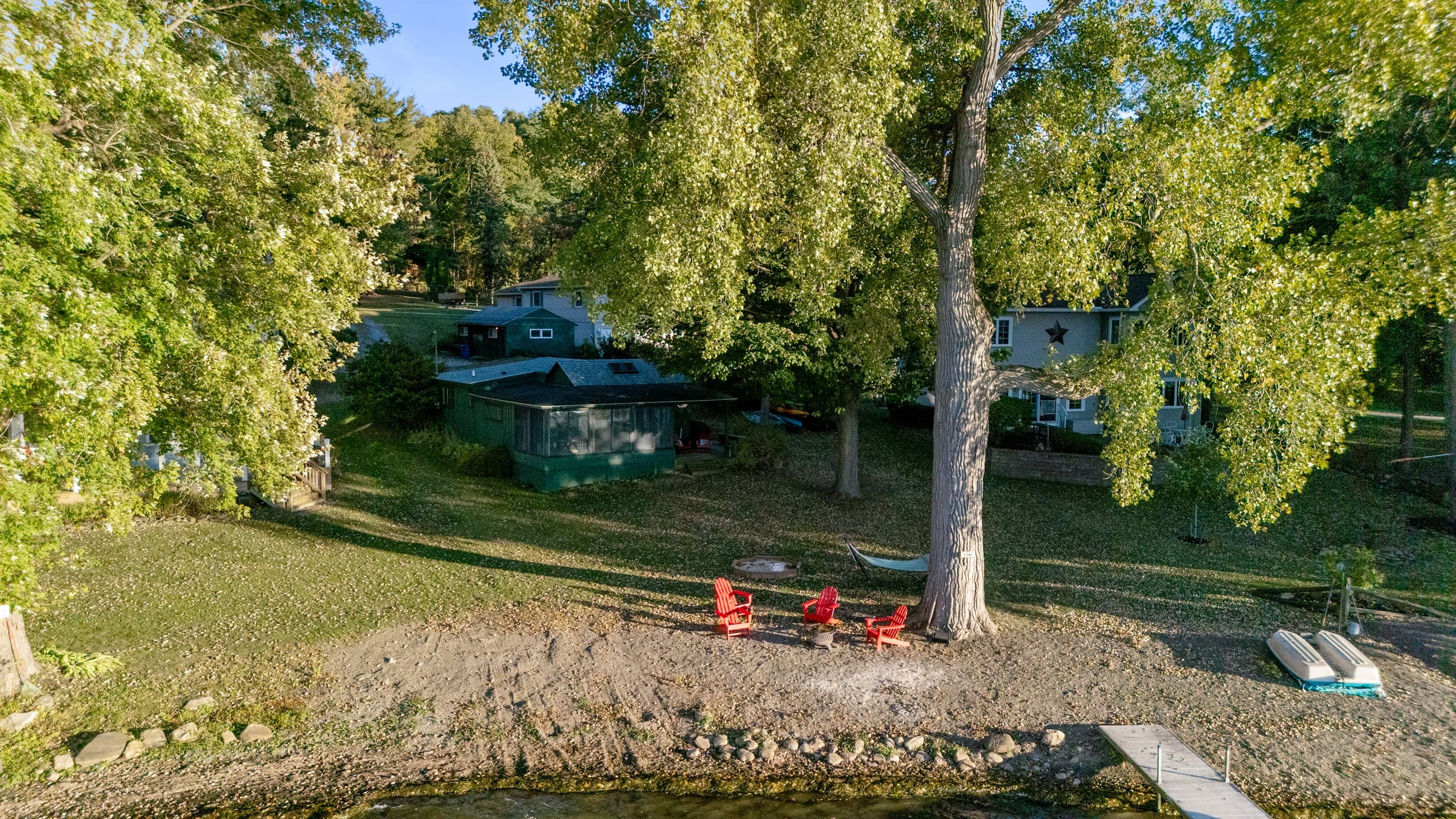 Shoreline seating beneath mature trees