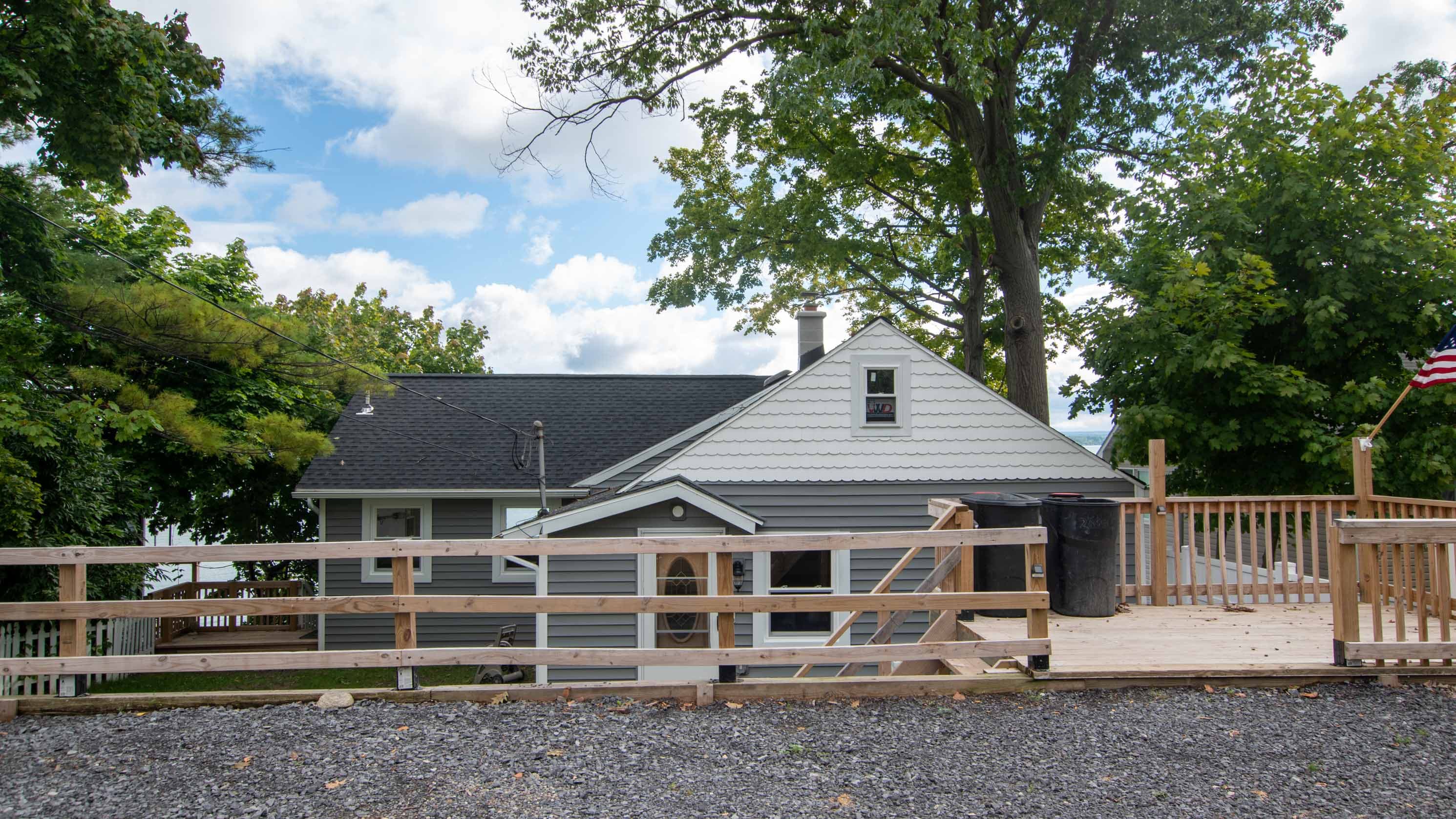 Side exterior with raised wooden deck