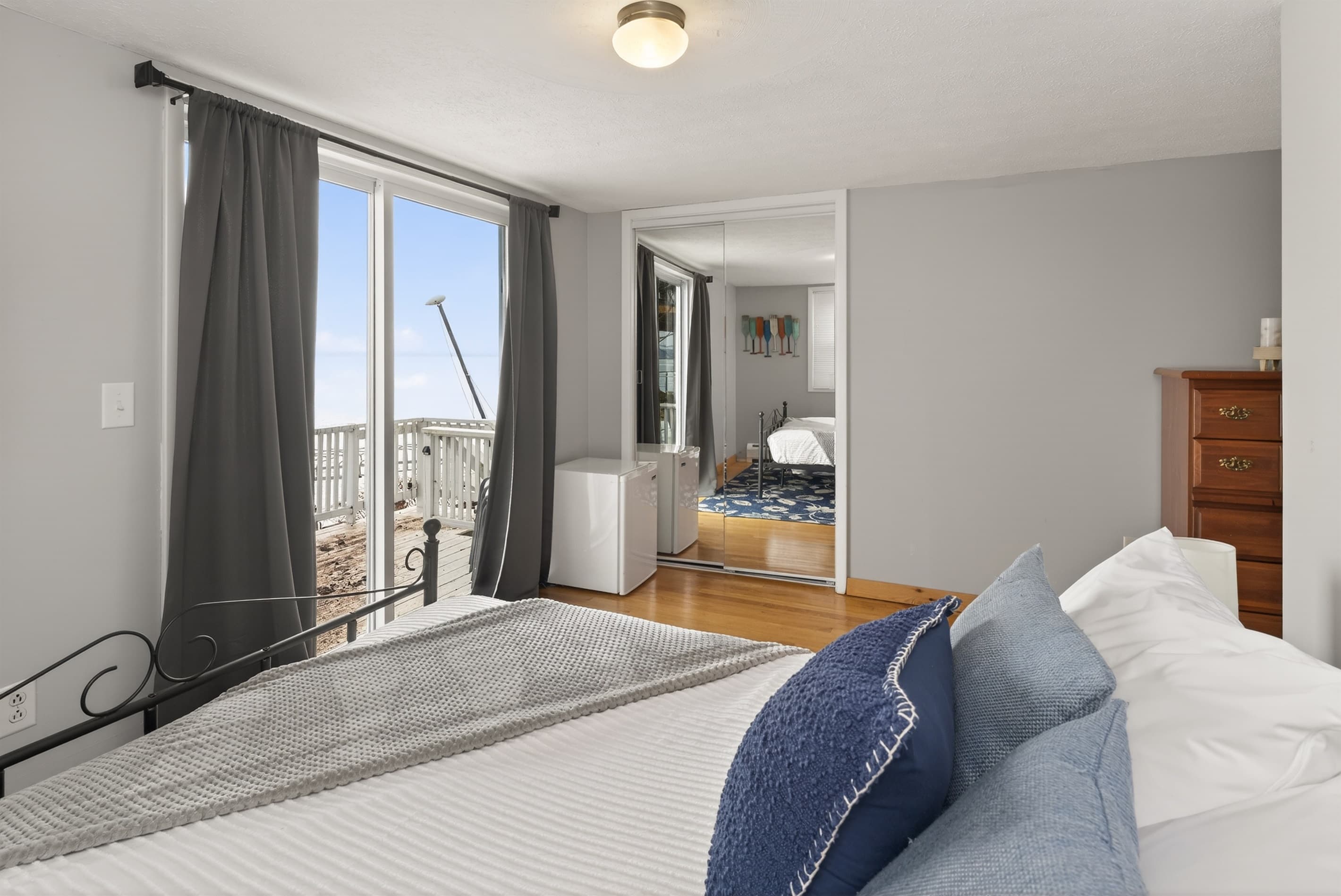 Bedroom with glass balcony doors and blue bed accents