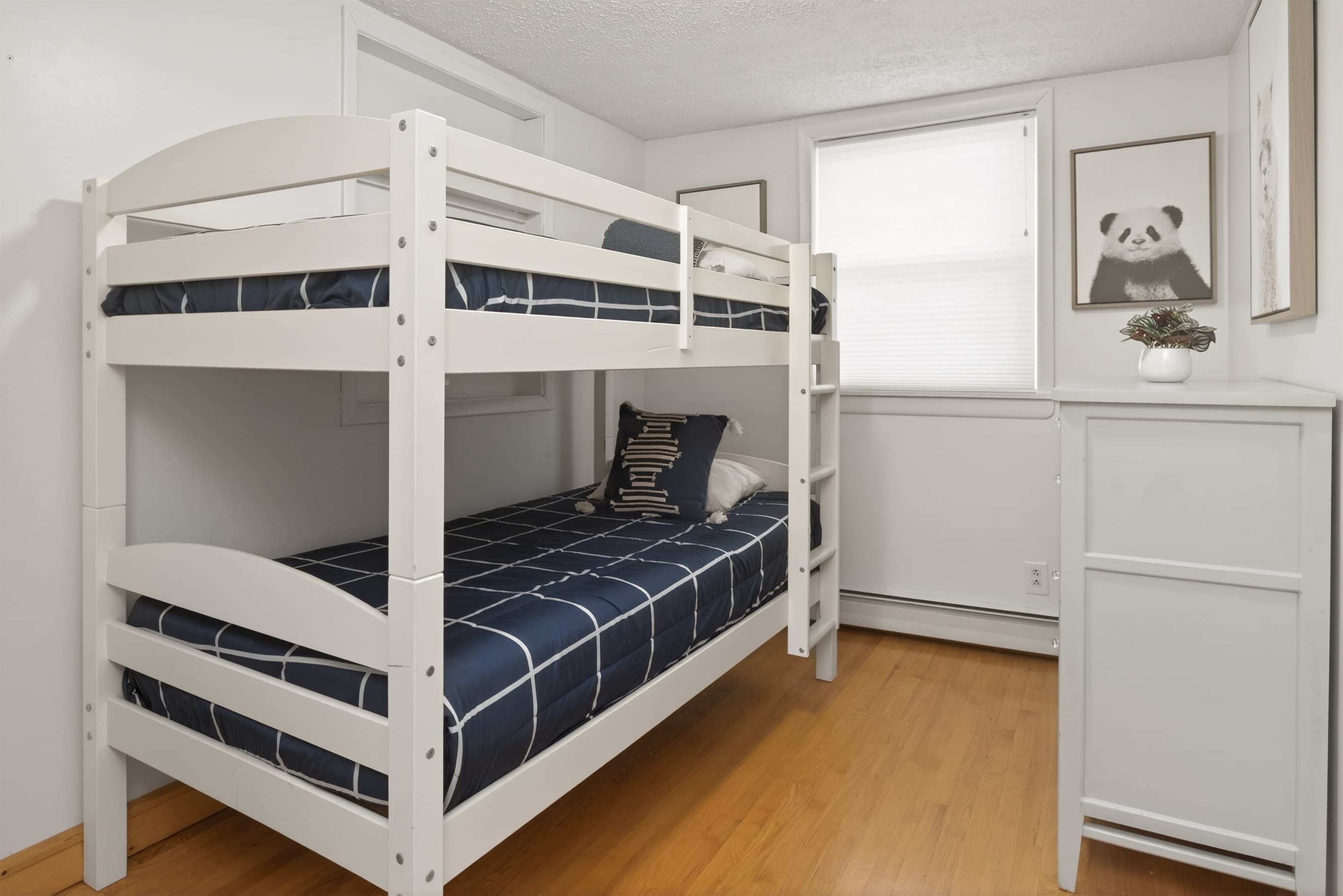 Twin bunk beds with white dresser