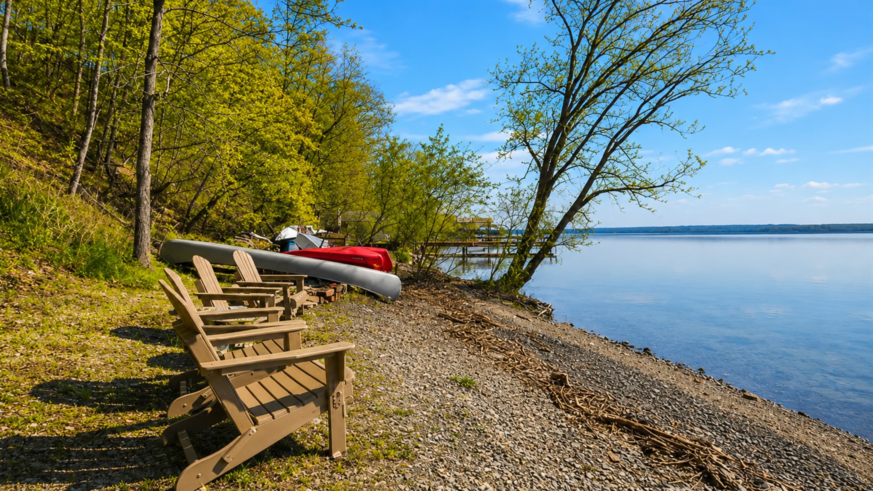 Wooden Adirondack chairs by the shoreline